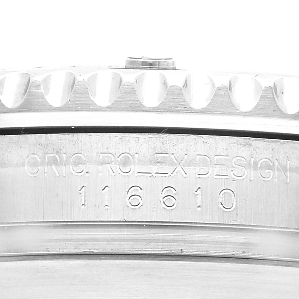 The image shows a close-up of the side of a Rolex Submariner 116610 Men
s Stainless Steel Black Dial 116610 Men
s Stainless Steel Black Dial model, displaying the engravings and part of the bezel.