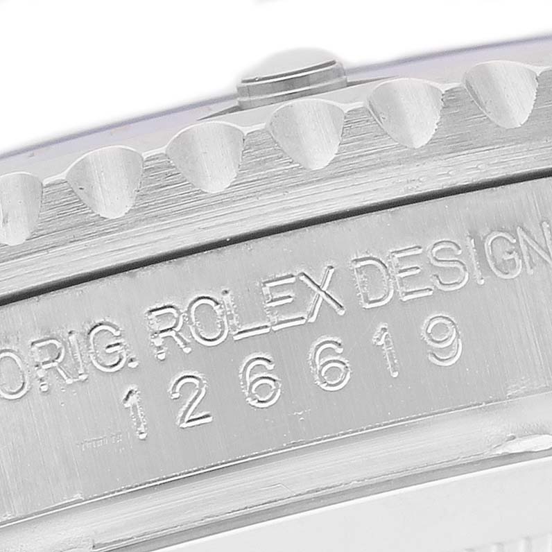 The image shows a close-up view of the casing side of a Rolex Submariner 126619 Men's White Gold Black Dial, highlighting the engraved serial number and bezel edge.
