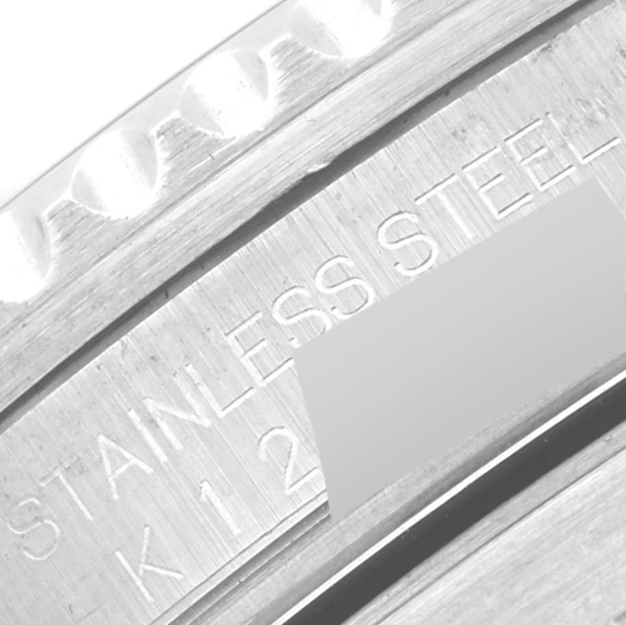 This image shows an angled close-up of the engraving on the stainless steel case of a Rolex Submariner 16610 Men
s Stainless Steel Black Dial 16610 Men
s Stainless Steel Black Dial watch.