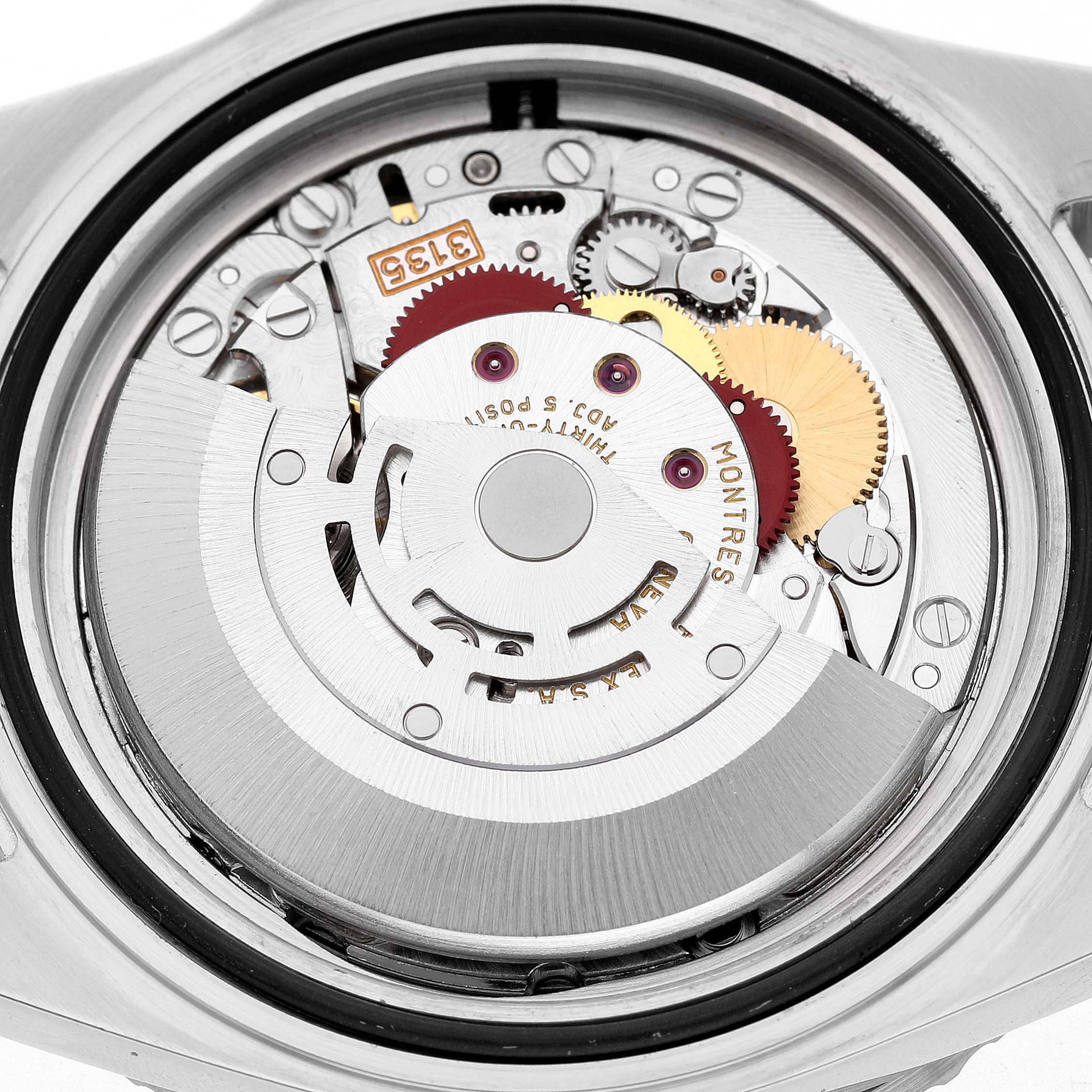 The image shows the Rolex Submariner 16610 Men's Stainless Steel Black Dial's movement from the back, displaying gears and mechanical components.