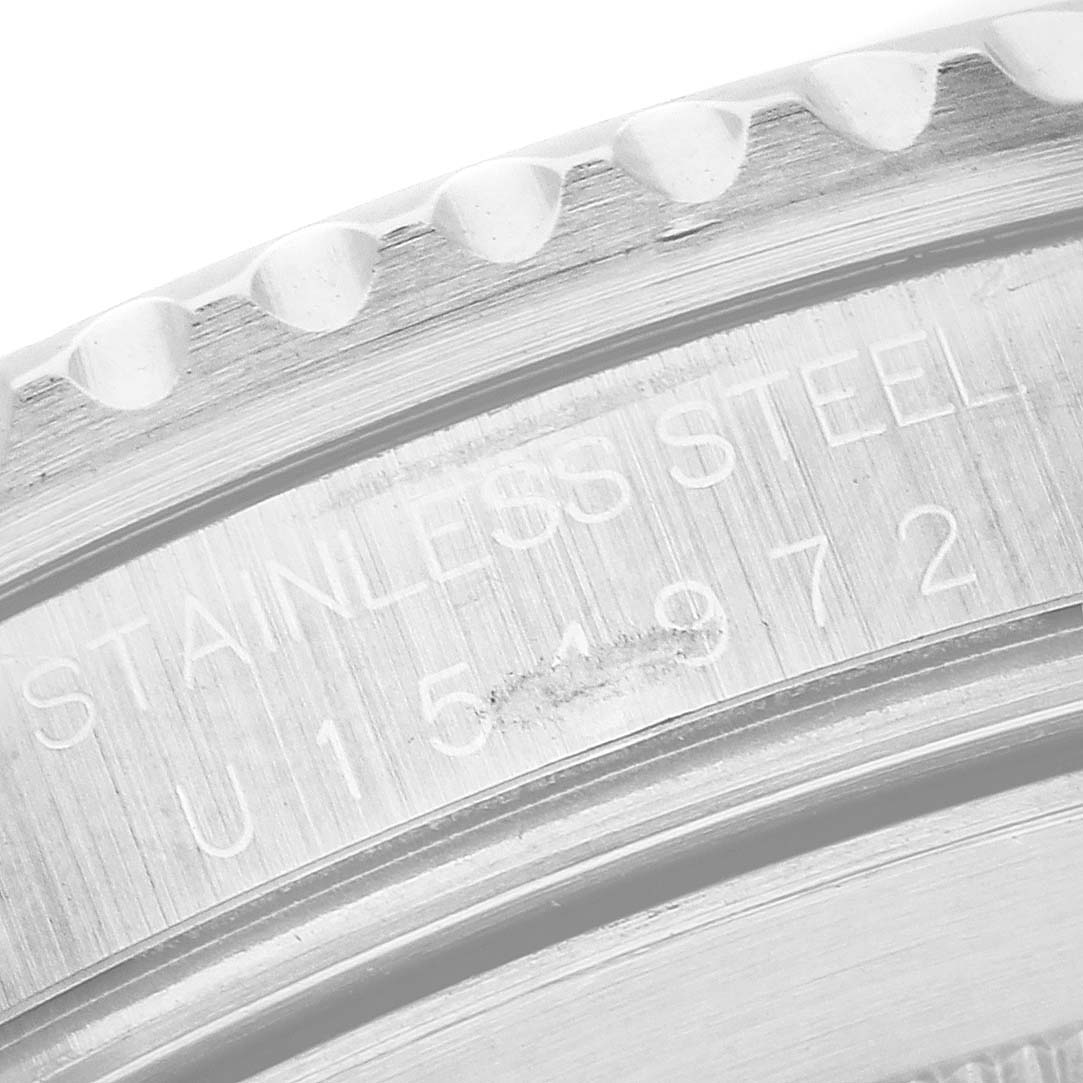 The image shows a close-up of the side engraving on the bezel of a Rolex Submariner 16610 Men's Stainless Steel Black Dial watch, highlighting the "STAINLESS STEEL" text.