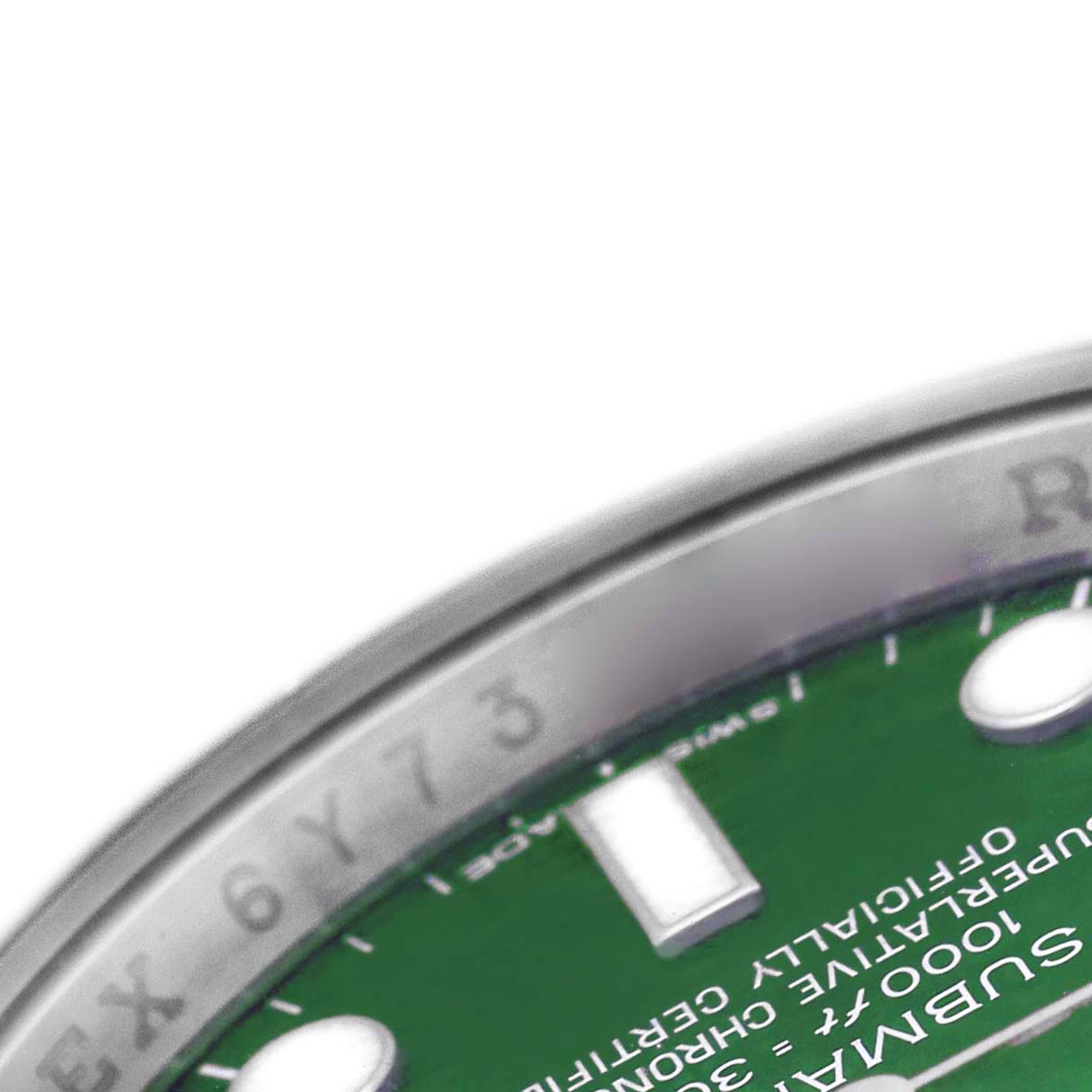 The image shows a close-up of the dial and edge of the bezel of a Rolex Submariner 116610LV Men's Stainless Steel Green Dial, focusing on the green face and text.