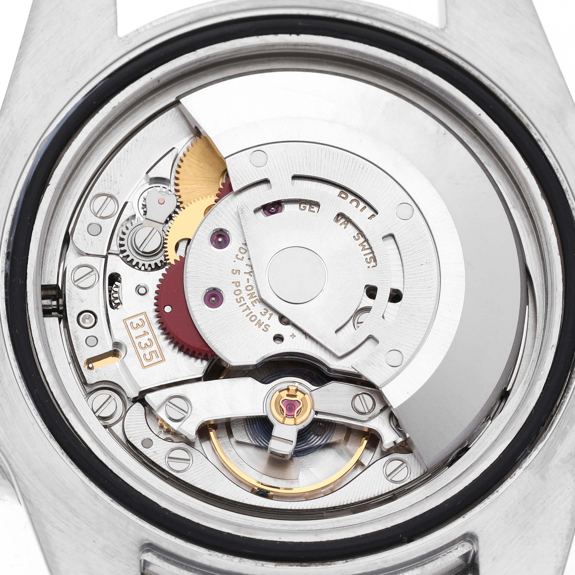 The image shows the movement mechanism of a Rolex Submariner 116610LV Men's Stainless Steel Green Dial watch from the back, highlighting gears and components.