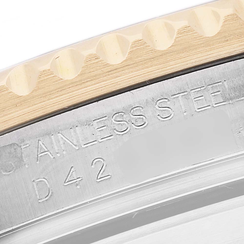This image shows a close-up of the bezel and case edge of a Rolex Submariner 16613 Men's Steel and Gold (two tone) Champagne Dial 16613 Men's Steel and Gold (two tone) Champagne Dial, highlighting the gold detailing and engraved text.