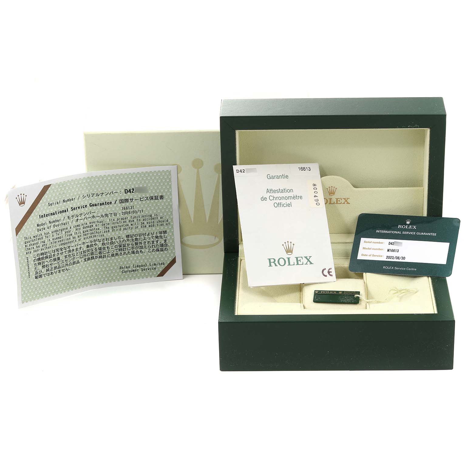 The image displays packaging, manuals, and certification cards for the Rolex Submariner 16613 Men's Steel and Gold (two tone) Champagne Dial 16613 Men's Steel and Gold (two tone) Champagne Dial model from a front angle.