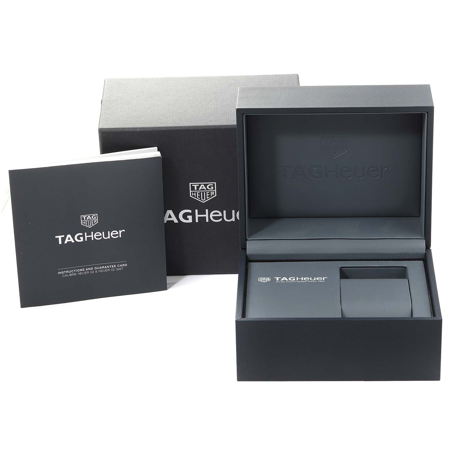 The image shows the box, instruction manual, and guarantee card for the Tag Heuer Carrera CBG2A1Z.BA0658 Men's Stainless Steel Black Dial CBG2A1Z.BA0658 Men's Stainless Steel Black Dial watch from a front angle.