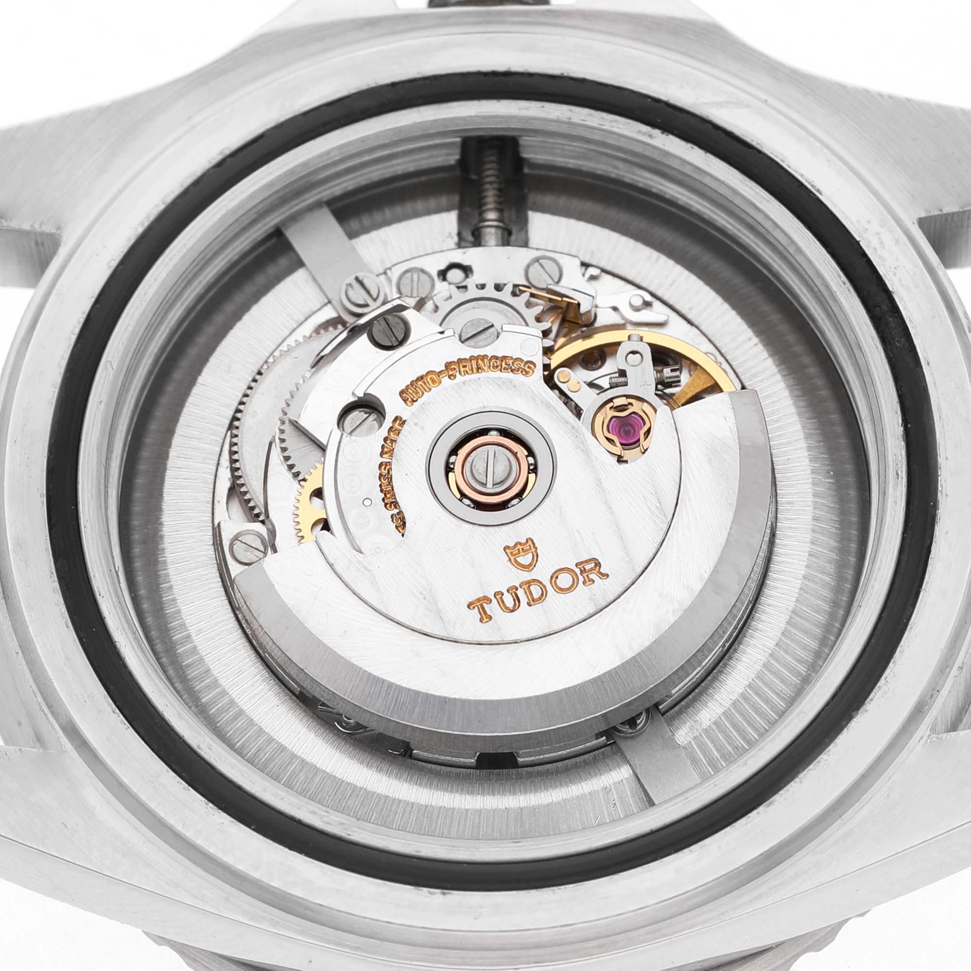 The image shows the movement of the Tudor Prince 73090 Men's Stainless Steel Black Dial watch from the back, highlighting the rotor, gears, and engravings.
