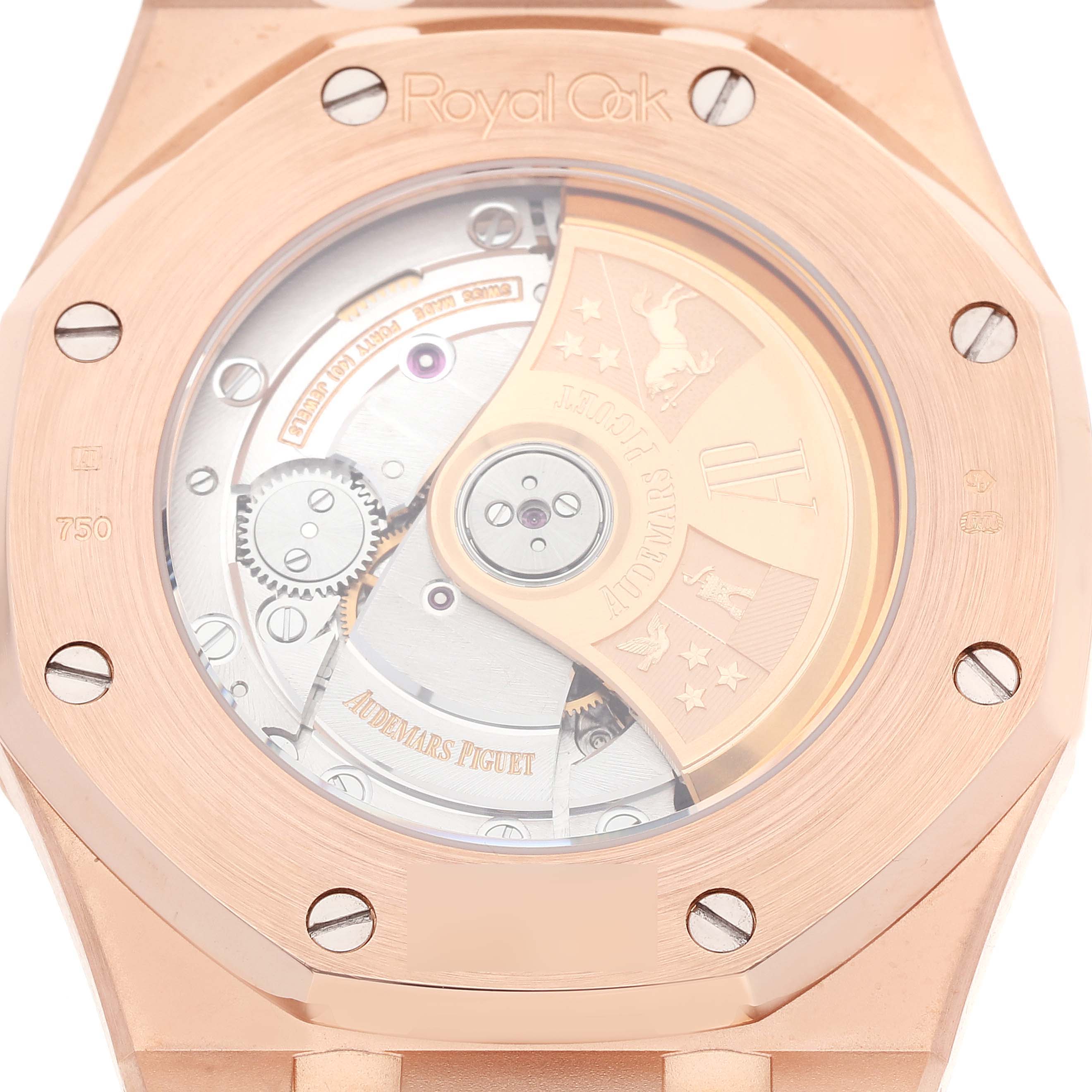 The image shows the caseback of a Royal Oak model by Audemars Piguet, displaying its intricate movement and rotor details.