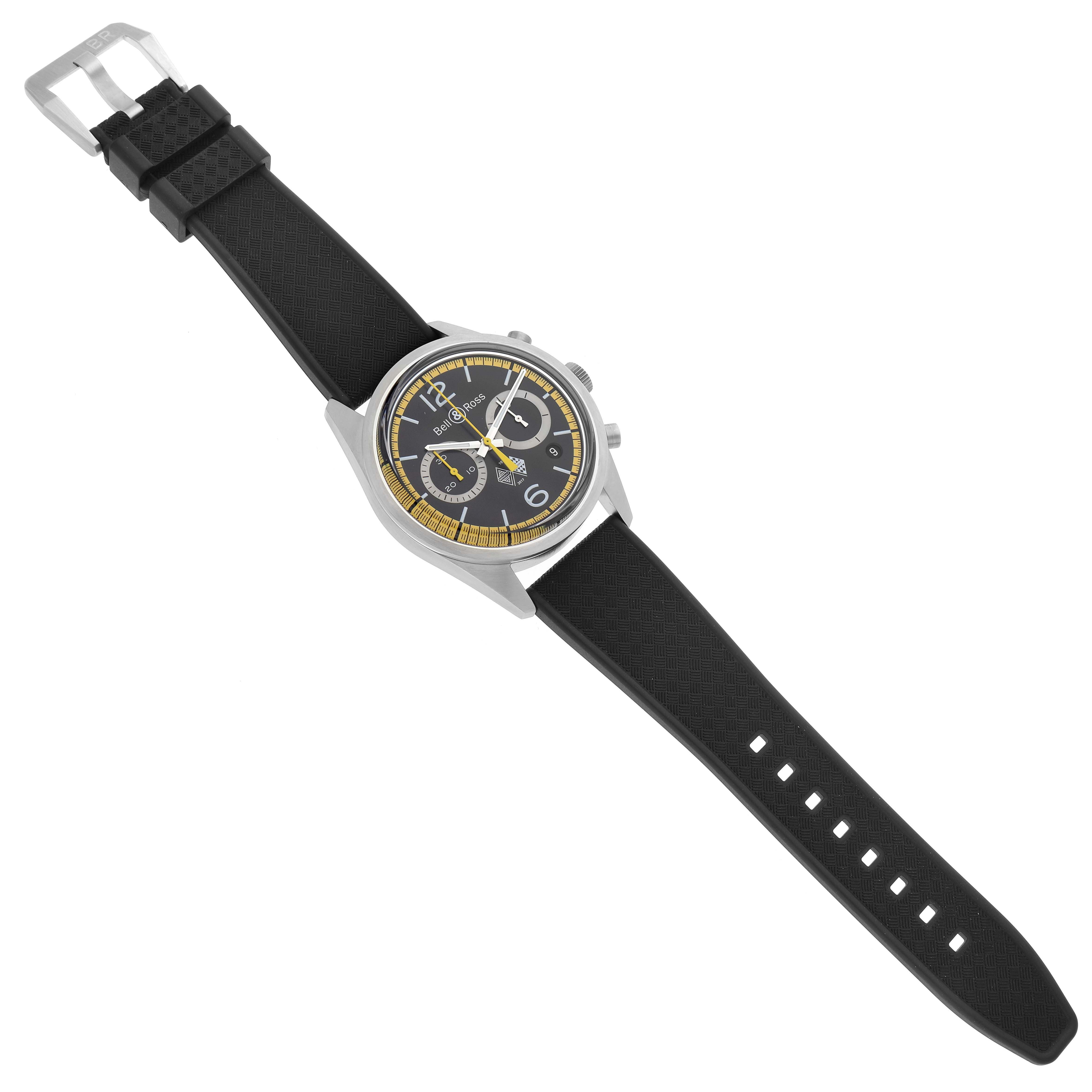 The image shows a top-down view of a Bell 
Ross Heritage BRV126-RS40-ST Men
s Stainless Steel Black Dial BRV126-RS40-ST Men
s Stainless Steel Black Dial model watch, featuring its black strap and detailed dial.