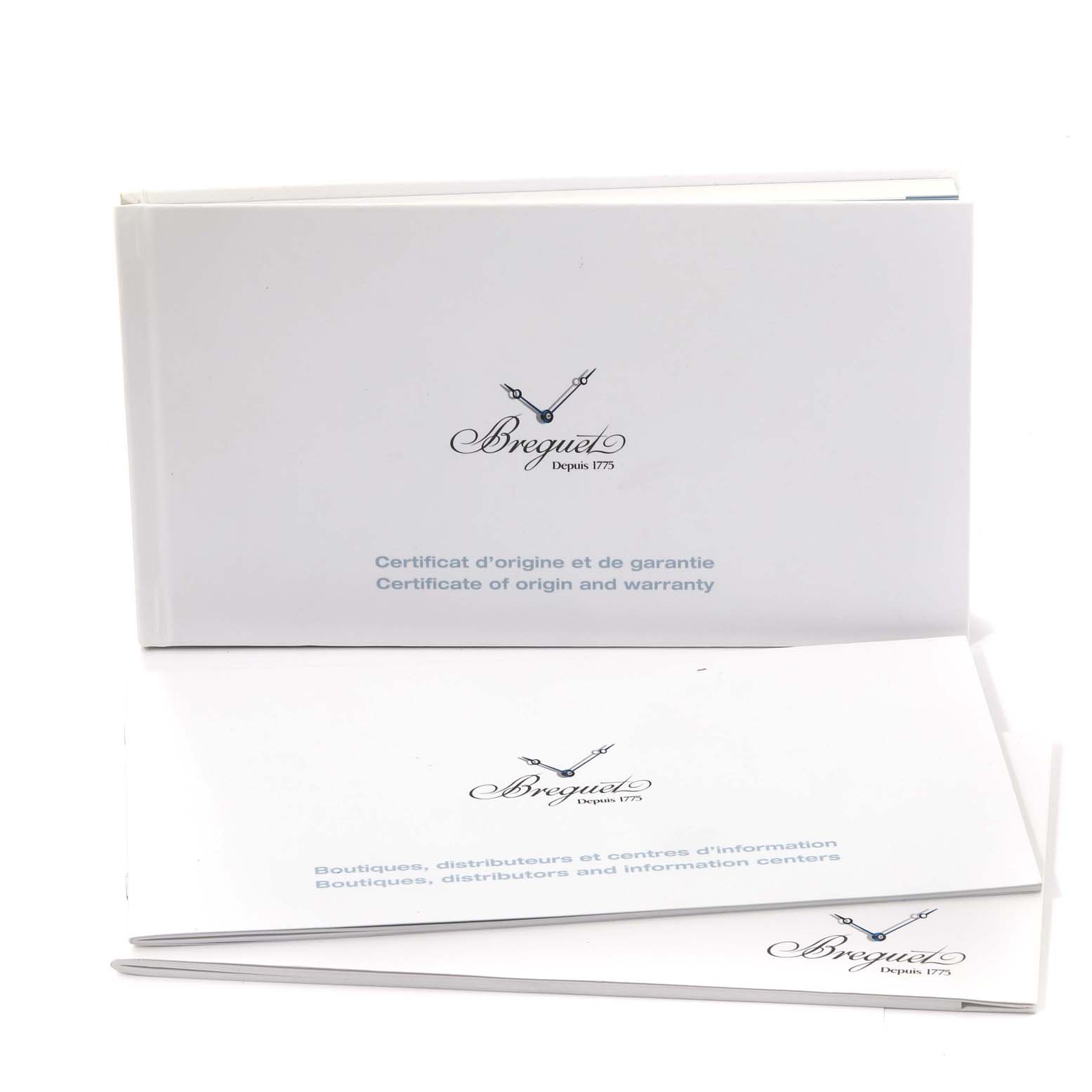 Shown are pamphlets for the Breguet Classique 5177BA/12/9V6 Men's Yellow Gold Silver Dial 5177BA/12/9V6 Men's Yellow Gold Silver Dial watch, including certificates of origin and warranty.