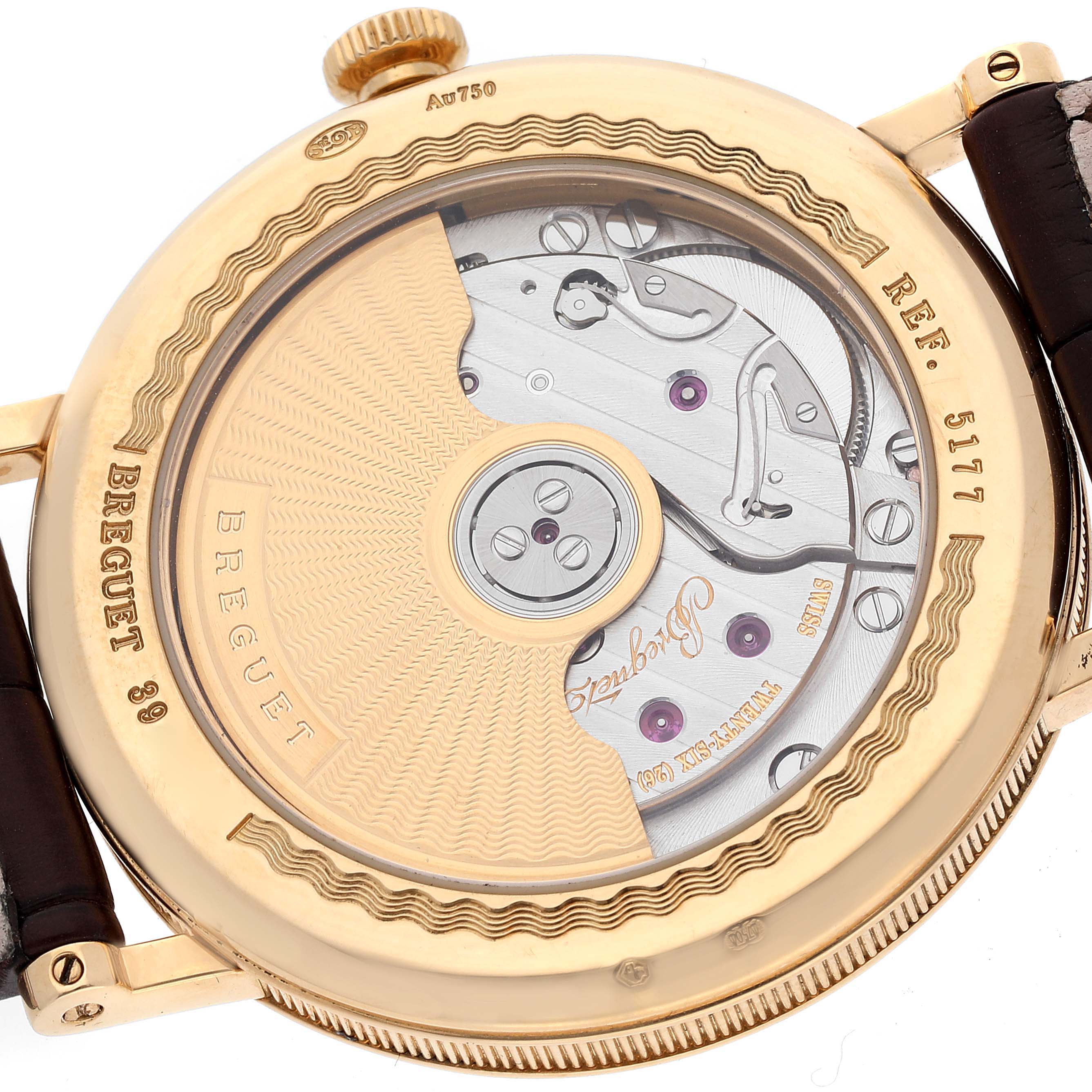 The image shows the back of the Breguet Classique 5177BA/12/9V6 Men's Yellow Gold Silver Dial 5177BA/12/9V6 Men's Yellow Gold Silver Dial model 5177, highlighting the intricate movement and inscriptions.