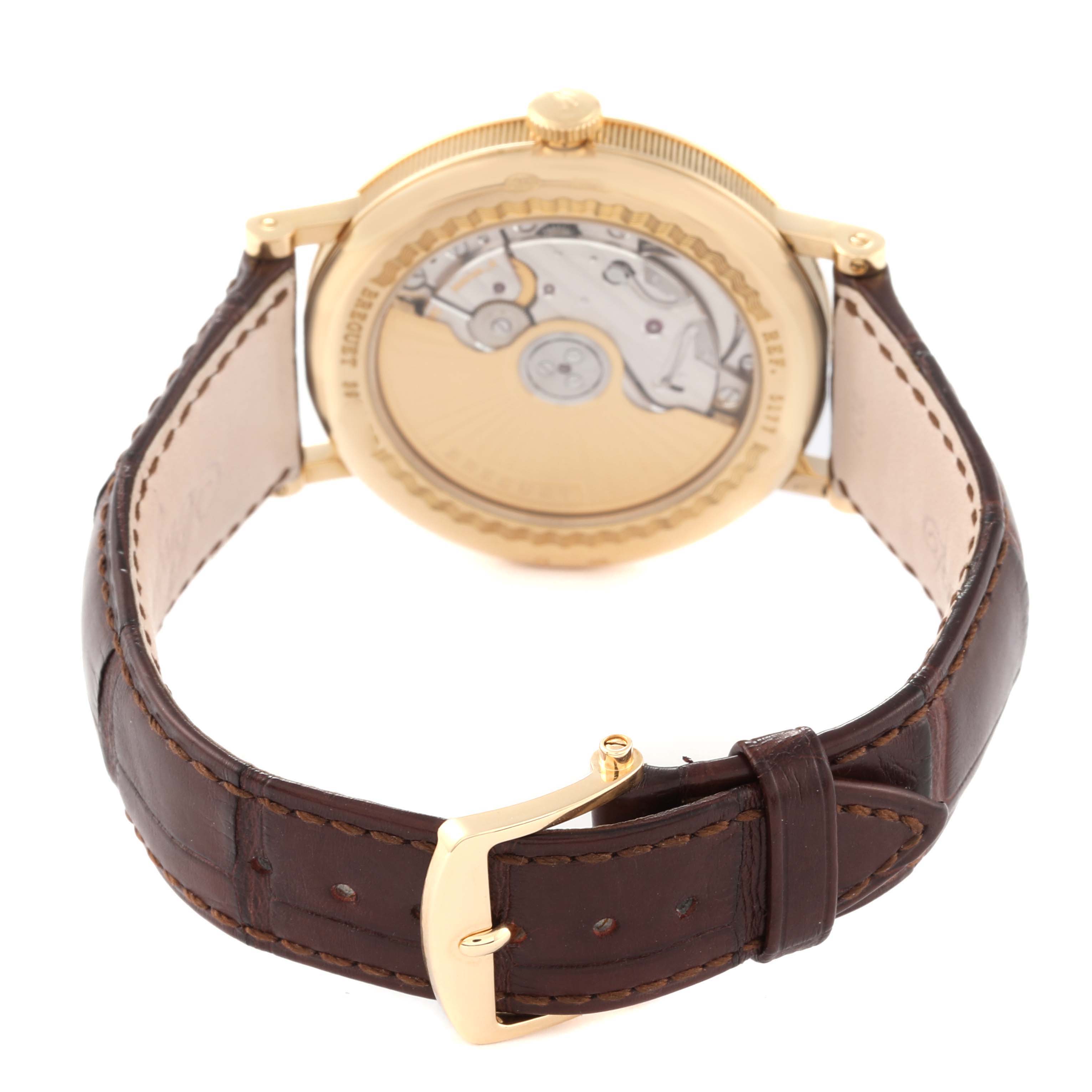 This image shows the back view of a Breguet Classique 5177BA/12/9V6 Men's Yellow Gold Silver Dial 5177BA/12/9V6 Men's Yellow Gold Silver Dial watch, highlighting its movement through a transparent case back and a leather strap.