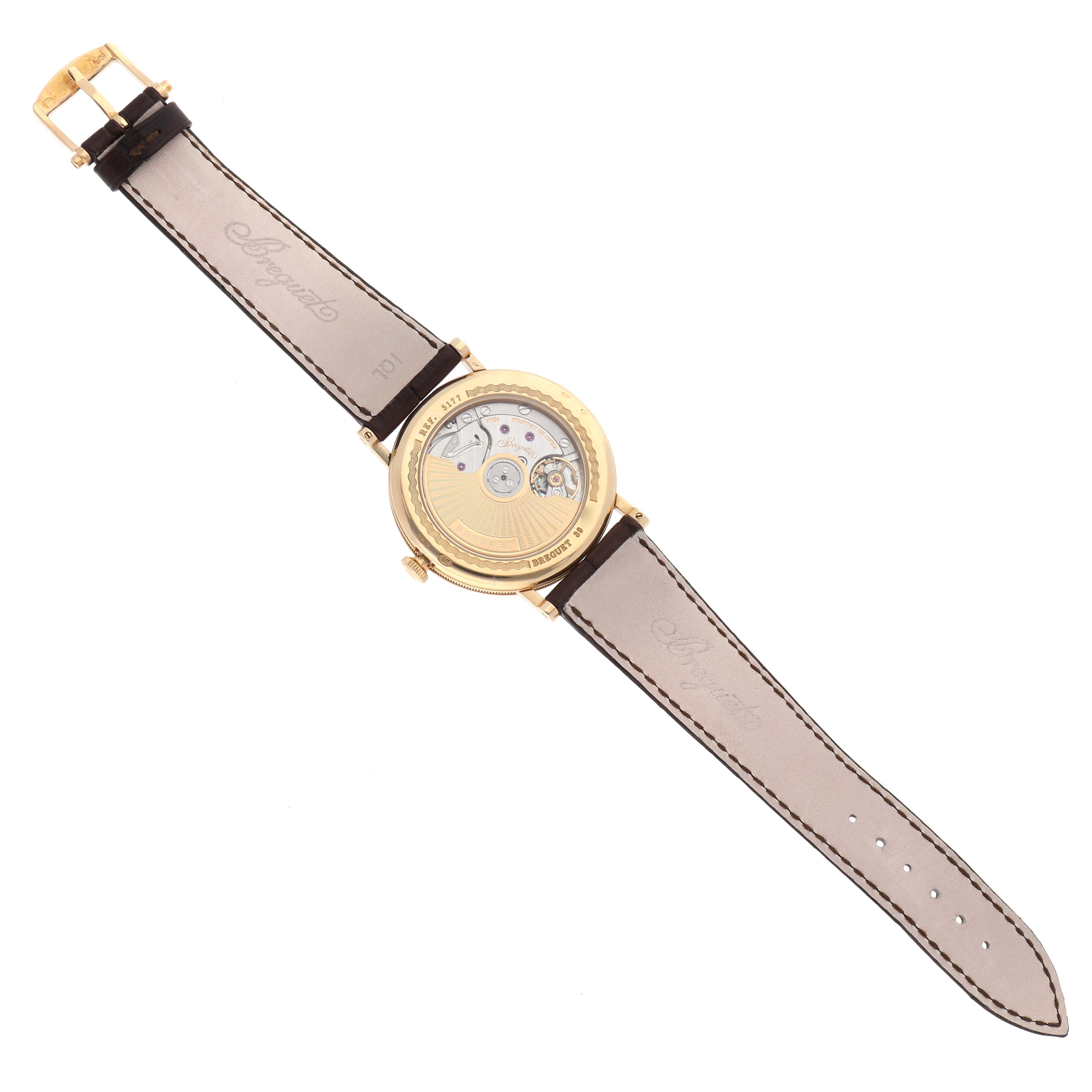 The image shows the back view of a Breguet Classique 5177BA/12/9V6 Men's Yellow Gold Silver Dial 5177BA/12/9V6 Men's Yellow Gold Silver Dial watch, highlighting the movement through a transparent case back.
