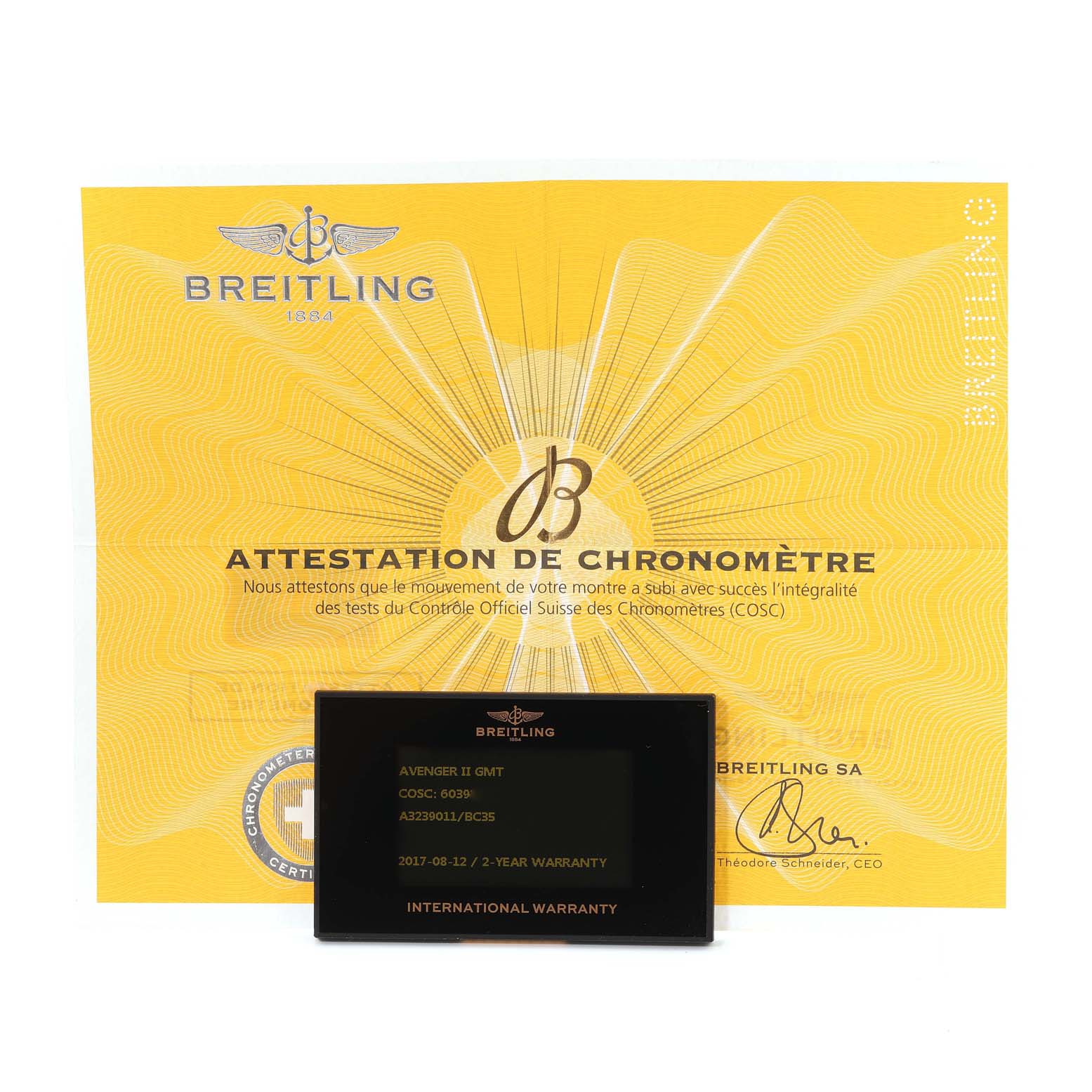 The image shows a Breitling Avenger A3239011/BC35 Men's Stainless Steel Black Dial A3239011/BC35 Men's Stainless Steel Black Dial II GMT warranty card and a yellow Certificate of Chronometer attestation.