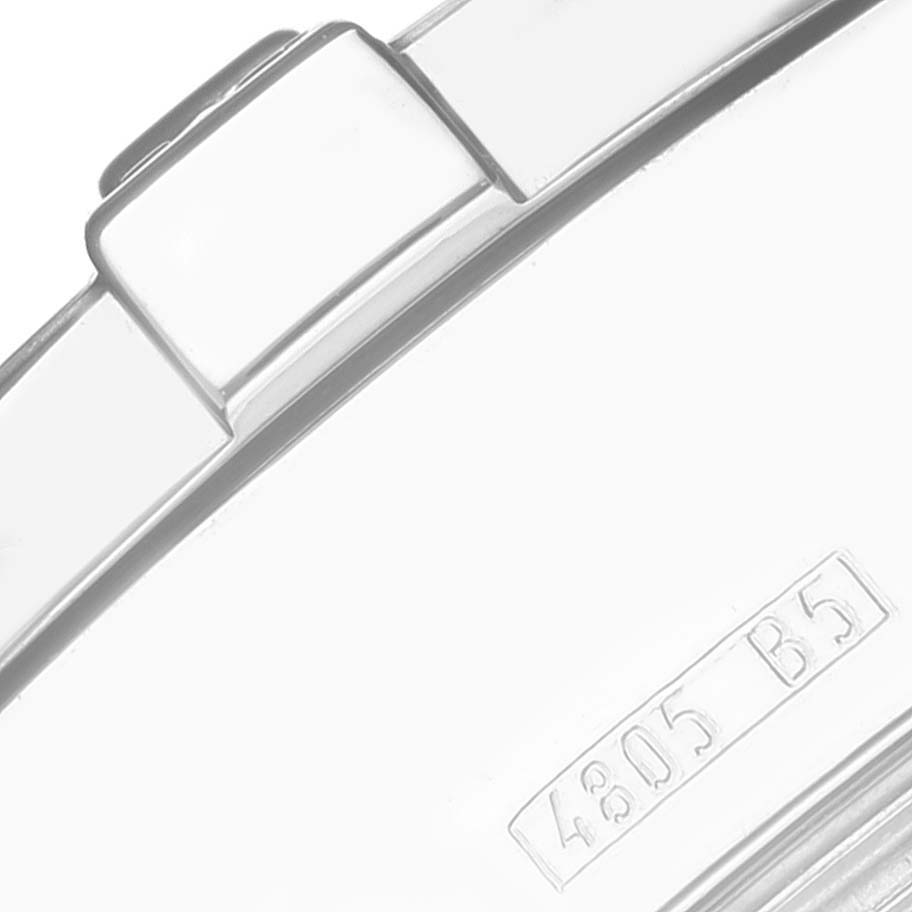 This image shows a close-up view of the side of a Breitling Superocean A13340 Men's Stainless Steel Silver Dial A13340 Men's Stainless Steel Silver Dial watch, highlighting part of the crown and case with an engraved marking.