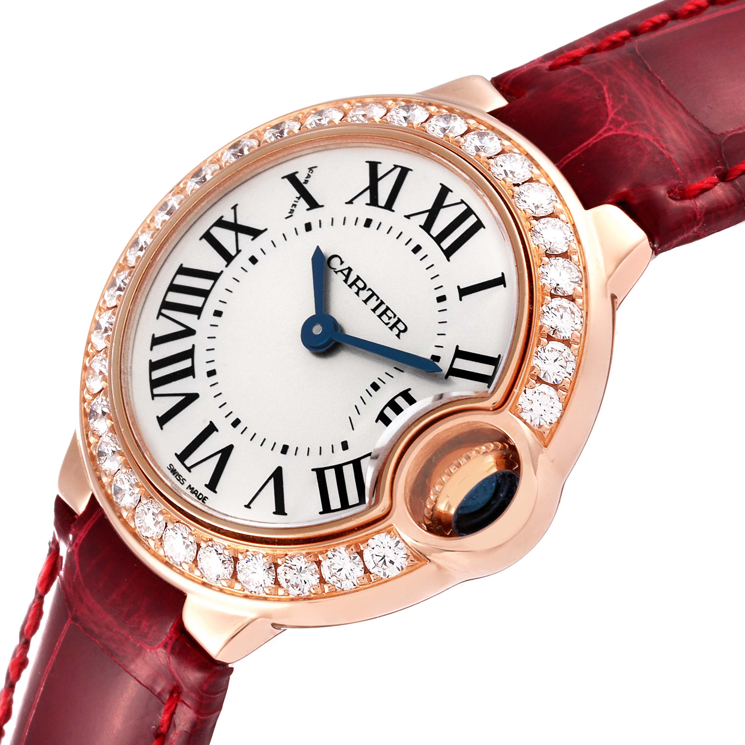 The Ballon Bleu model by Cartier is shown at an angled view, highlighting the face, diamond-set bezel, and red leather strap.