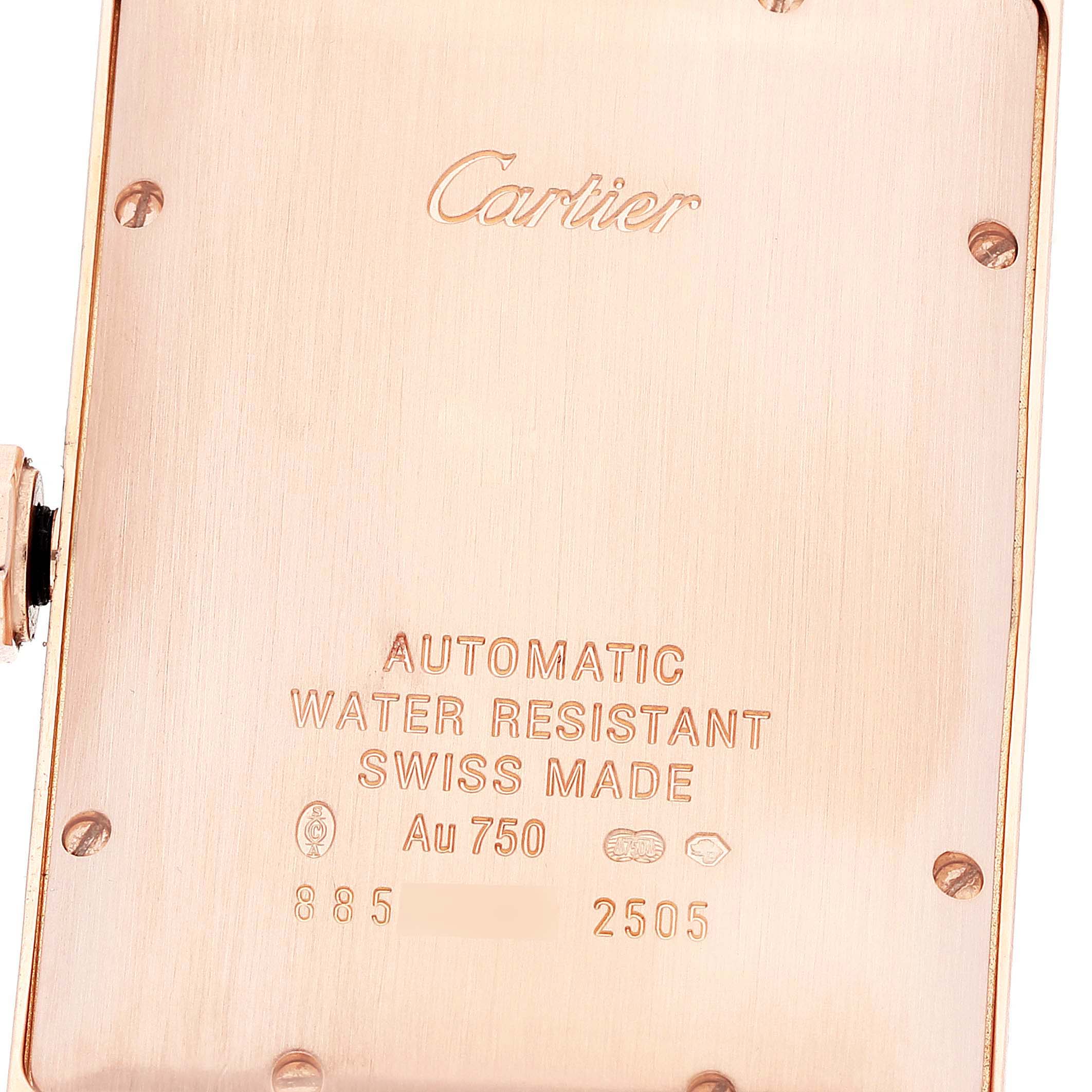 This image shows the back case of a Cartier Tank Américaine watch, revealing engravings and screws.