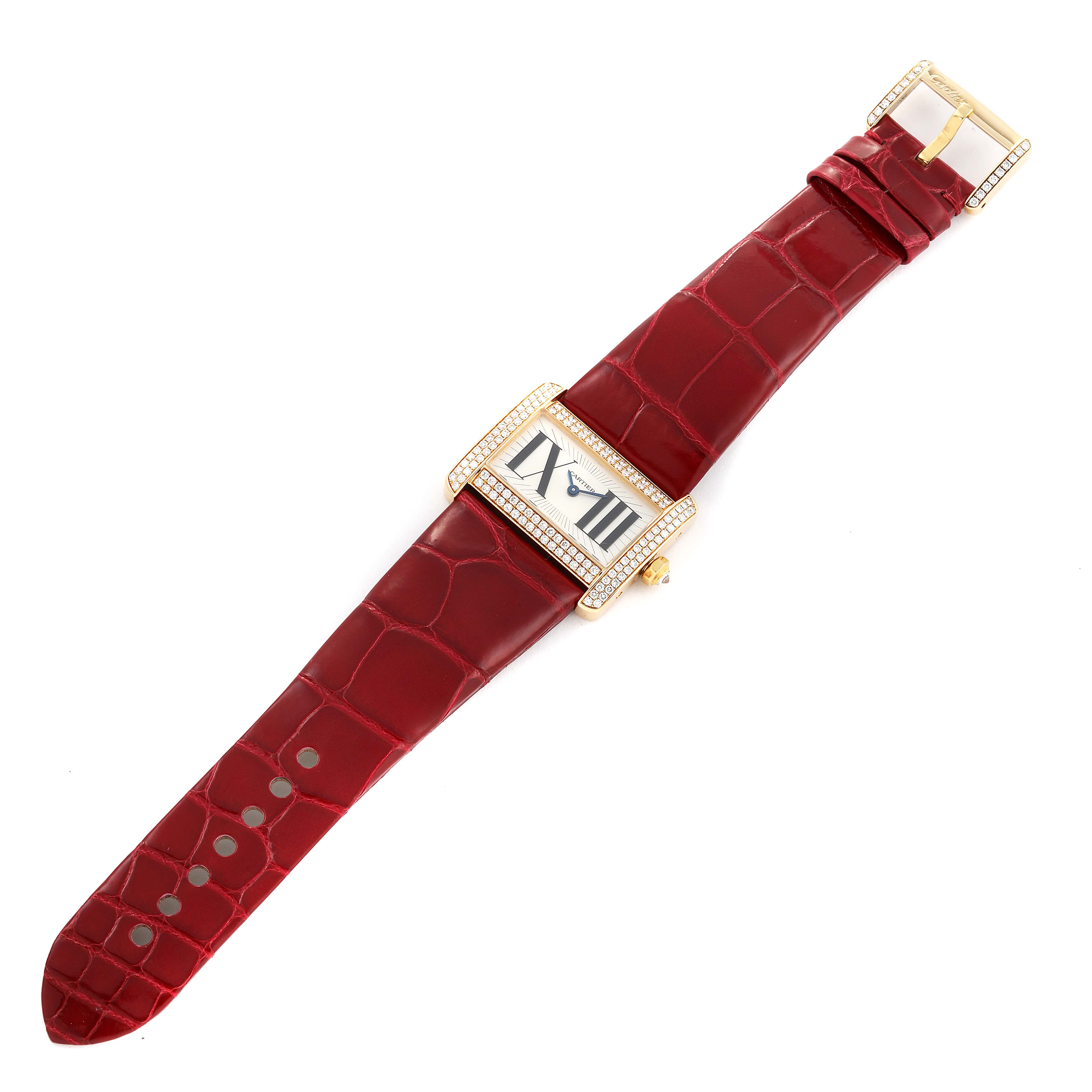 The Cartier Tank Divan WA301471 Women
s Yellow Gold Silver Dial WA301471 Women
s Yellow Gold Silver Dial watch is shown from a top-down angle, displaying its red straps, rectangular face, and gold-tone bezel with diamonds.