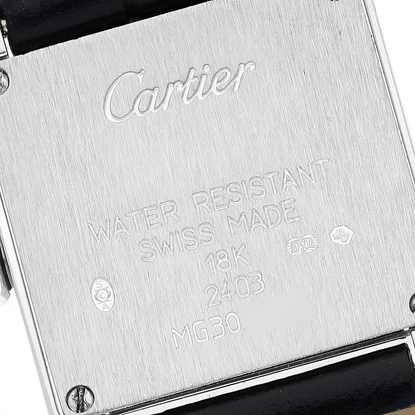 The image shows the backside of a Tank Francaise watch by Cartier, featuring engraved details such as water resistance and Swiss-made marks.