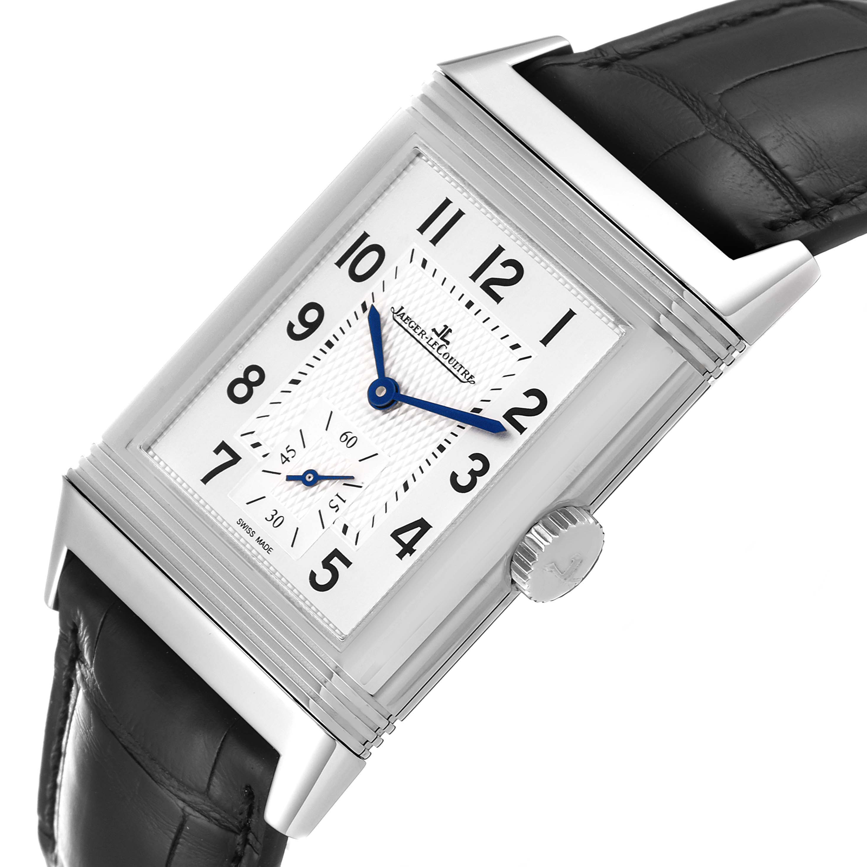 The Jaeger-LeCoultre Reverso watch is shown from a slightly tilted angle, highlighting its rectangular dial, blue hands, and black leather strap.