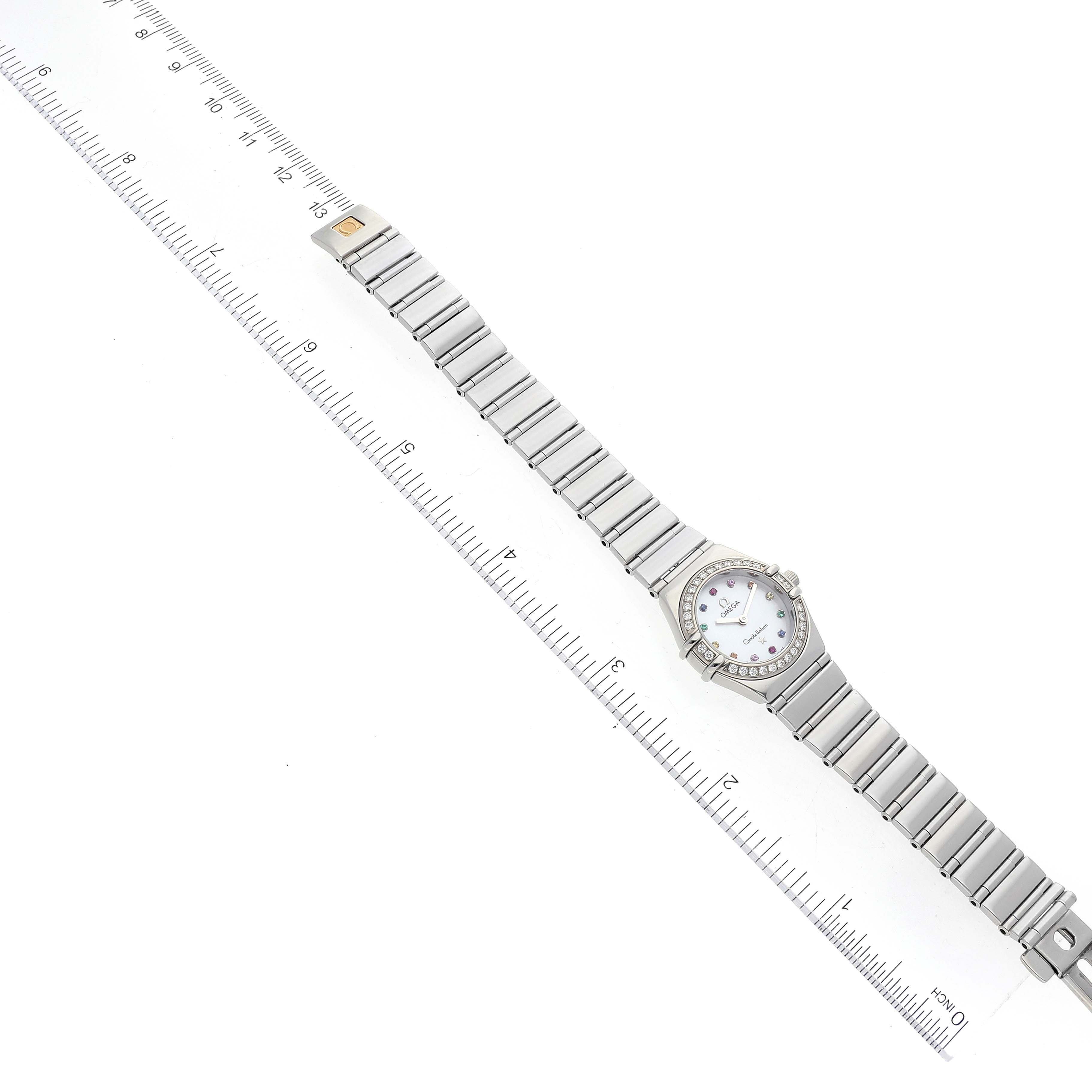 The Omega 1465.79.00 Women
s Stainless Steel Mother of Pearl Dial 1465.79.00 Women
s Stainless Steel Mother of Pearl Dial Constellation Iris My Choice Steel Mother of Pearl Multi Stone Ladies Watch 1465.79.00 is shown lying flat with a full view of the band and face next to a ruler.