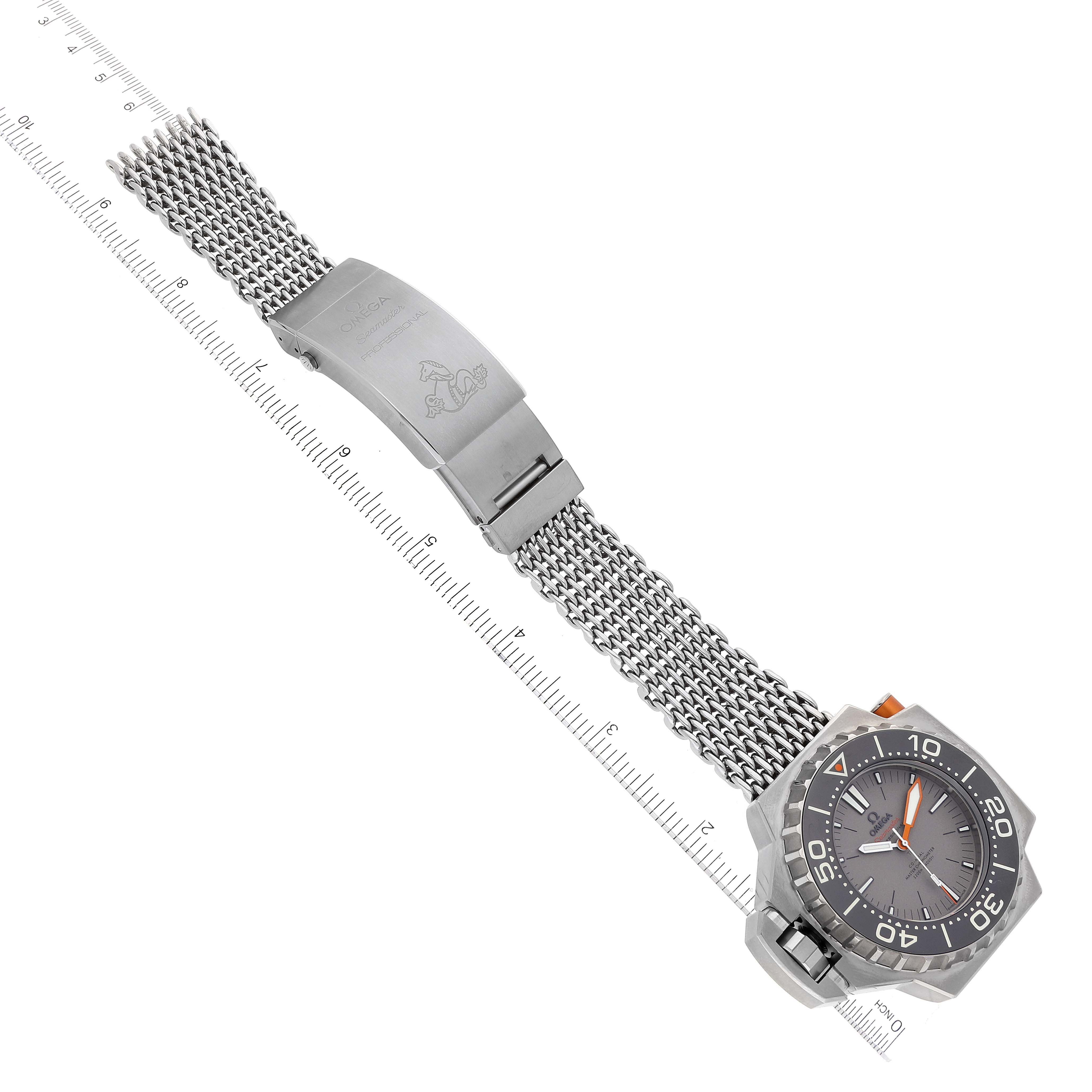 The image shows an overhead view of an Omega Ploprof 227.90.55.21.99.001 Men's Titanium Grey Dial 227.90.55.21.99.001 Men's Titanium Grey Dial model watch, highlighting the watch face, bezel, and the metal mesh bracelet with a clasp.