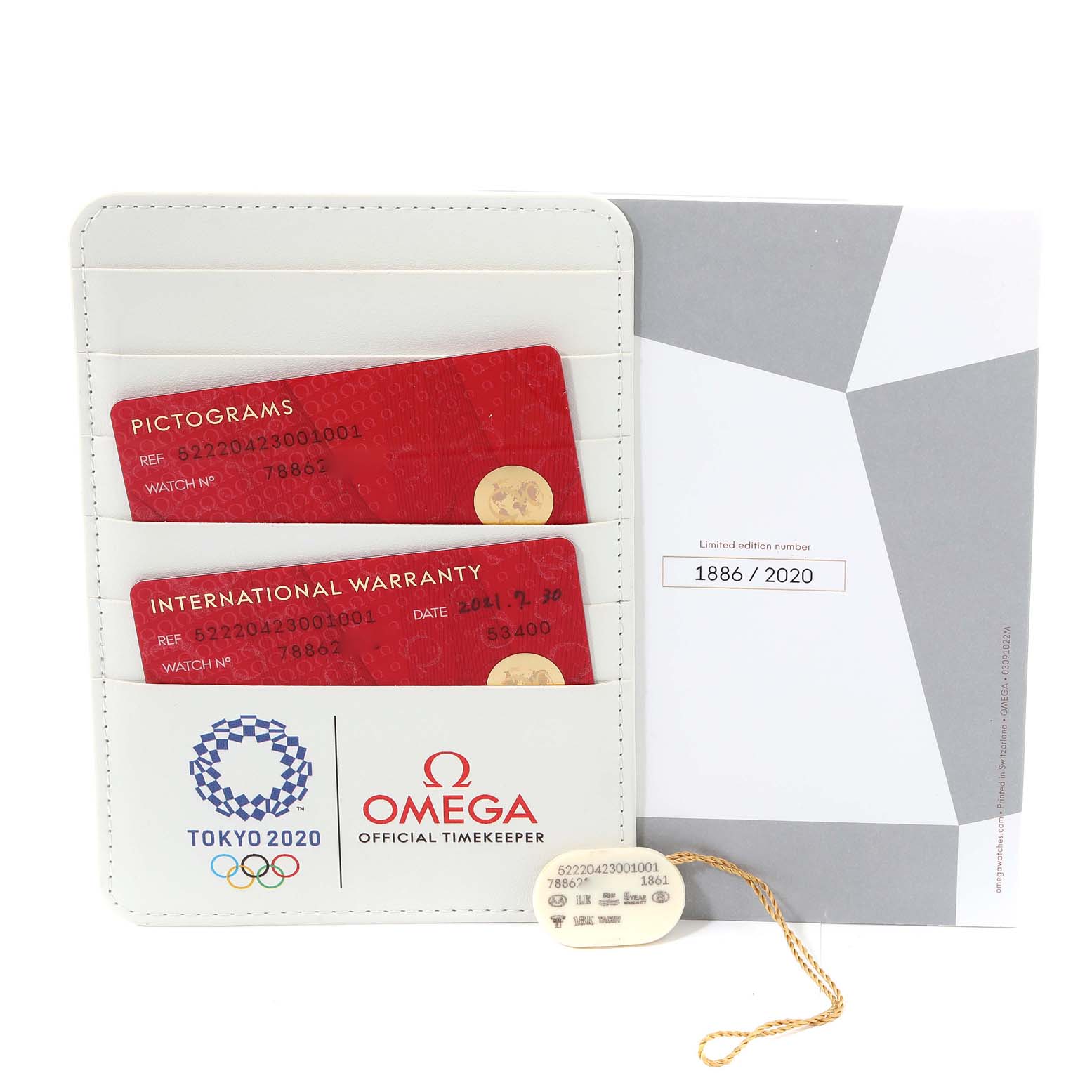 The image shows the Omega Speedmaster 522.20.42.30.01.001 Men's Steel and Gold (two tone) Black Dial 522.20.42.30.01.001 Men's Steel and Gold (two tone) Black Dial warranty cards in a holder, documentation, and a tag.