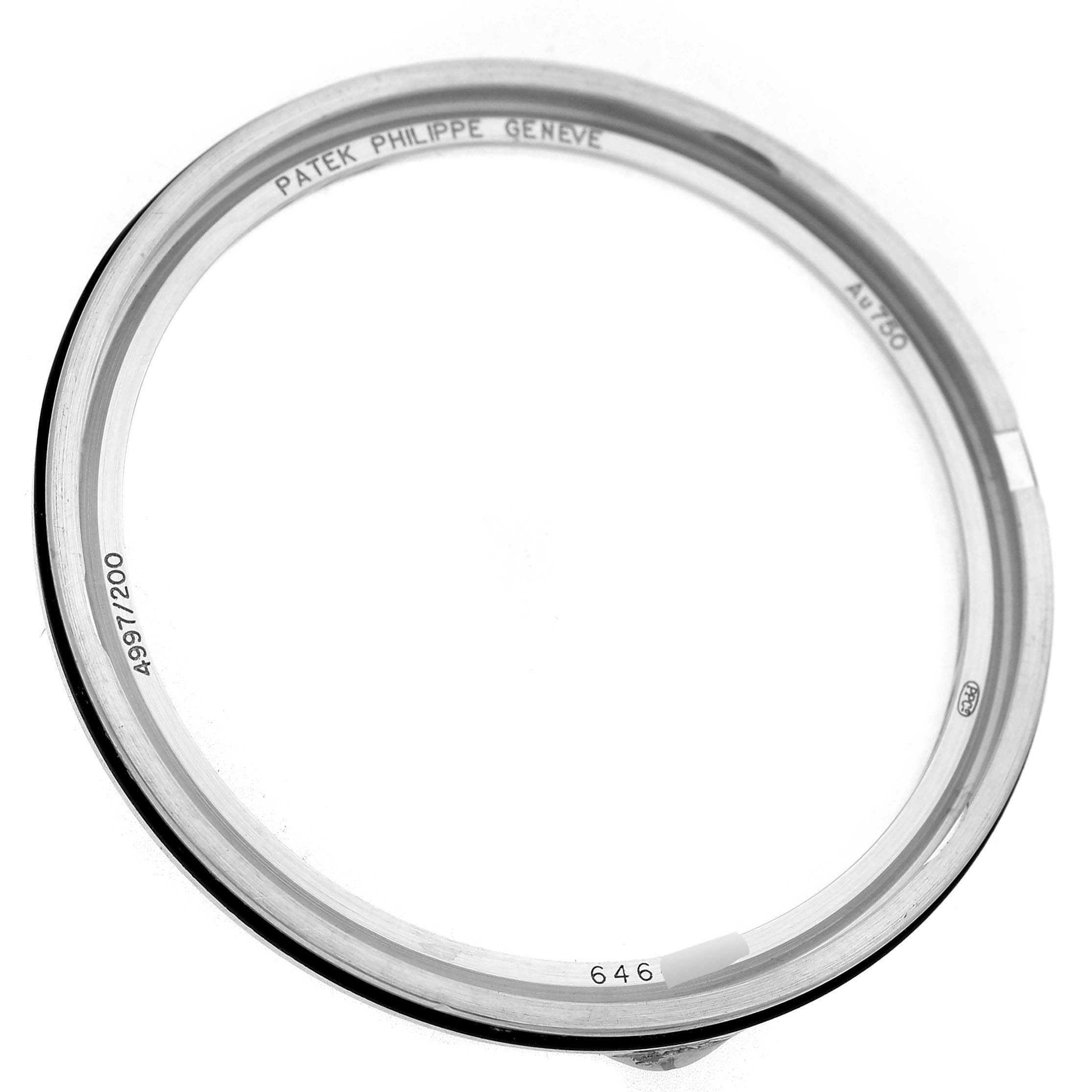 The image shows a bezel for the Patek Philippe Calatrava 4997 Women's White Gold Blue Dial, viewed from above, engraved with branding and serial details.