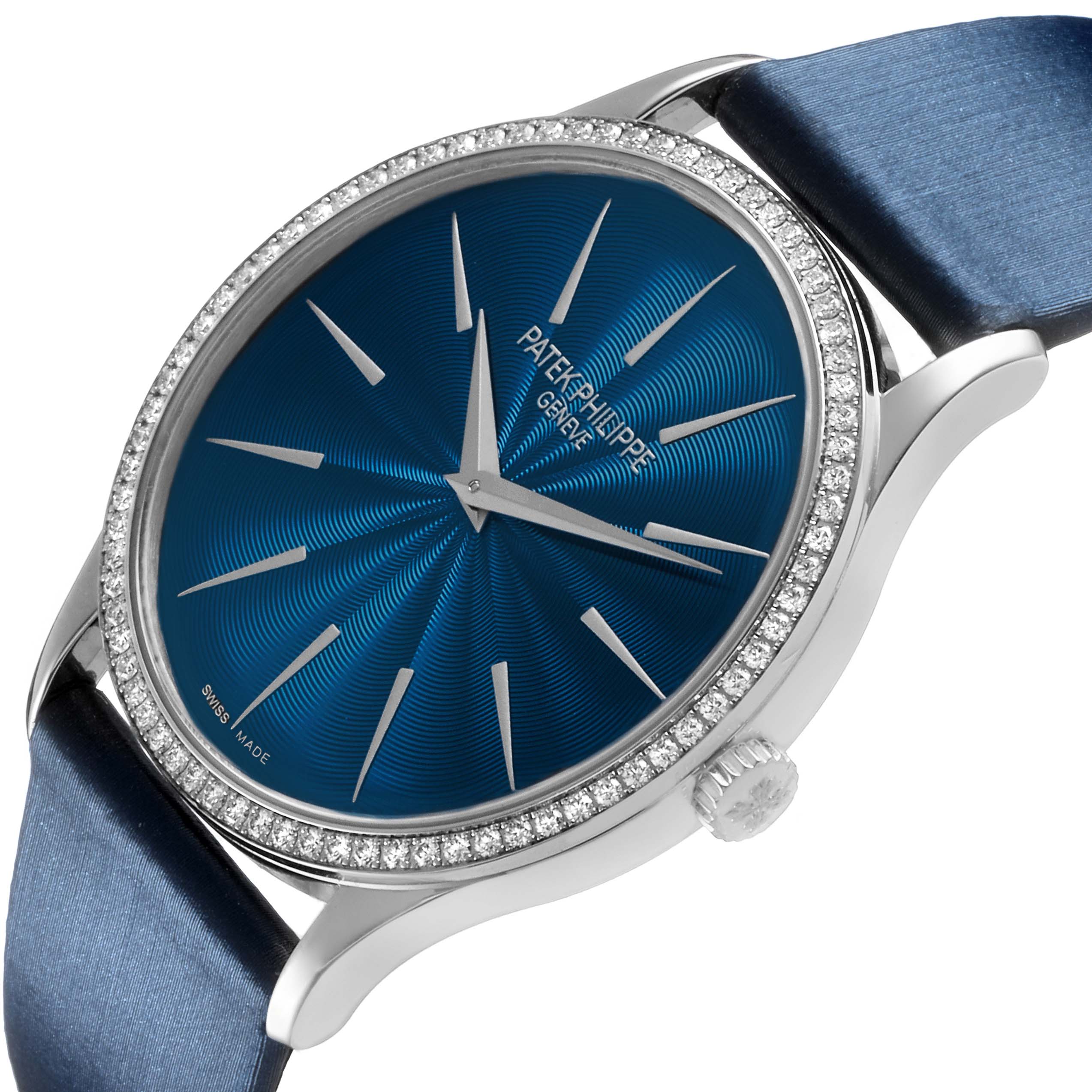 The Patek Philippe Calatrava 4997 Women's White Gold Blue Dial watch is shown at an angle displaying the blue dial, diamond bezel, and part of the strap.