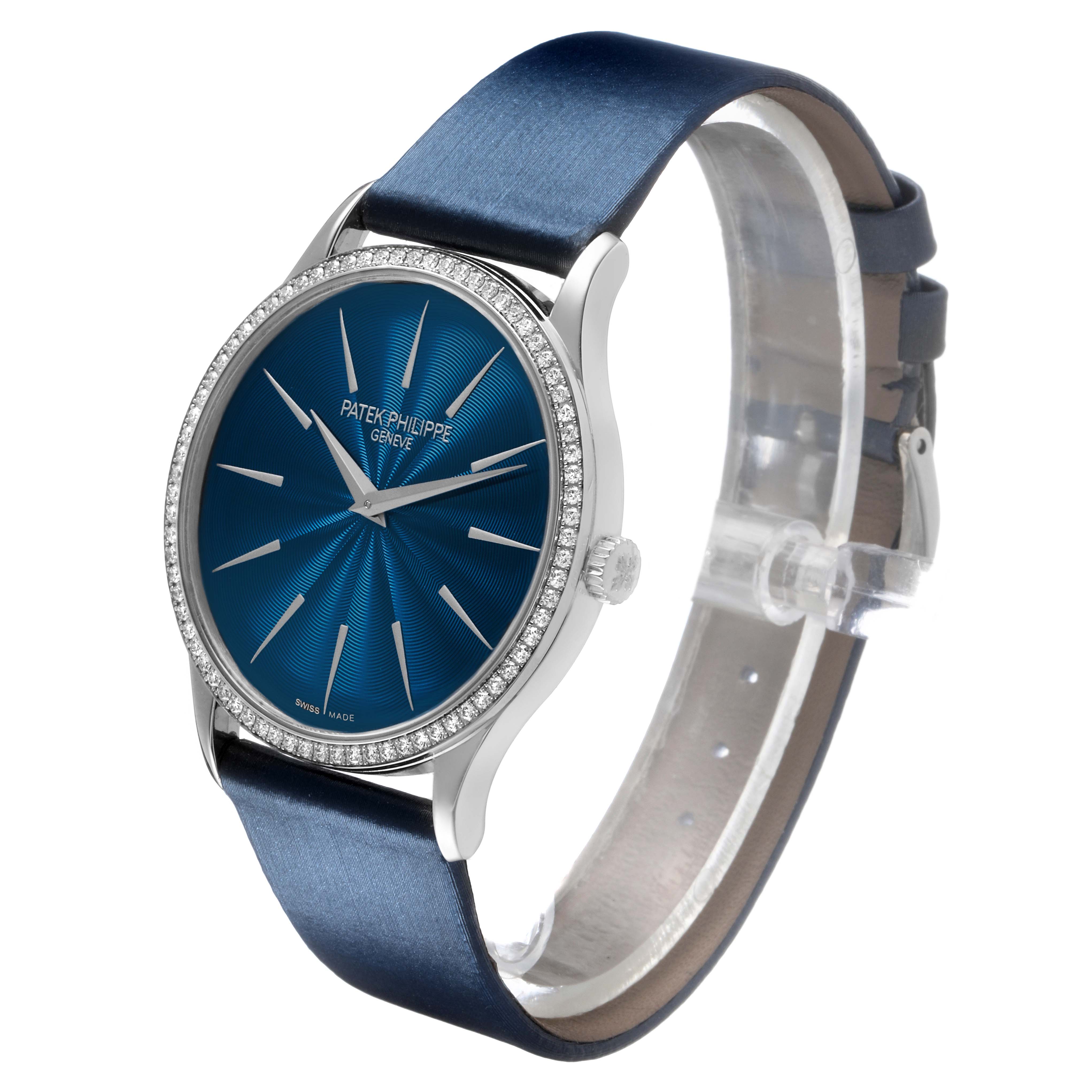 The Patek Philippe Calatrava 4997 Women's White Gold Blue Dial watch is shown at a three-quarter angle, displaying the dial, bezel, and strap.