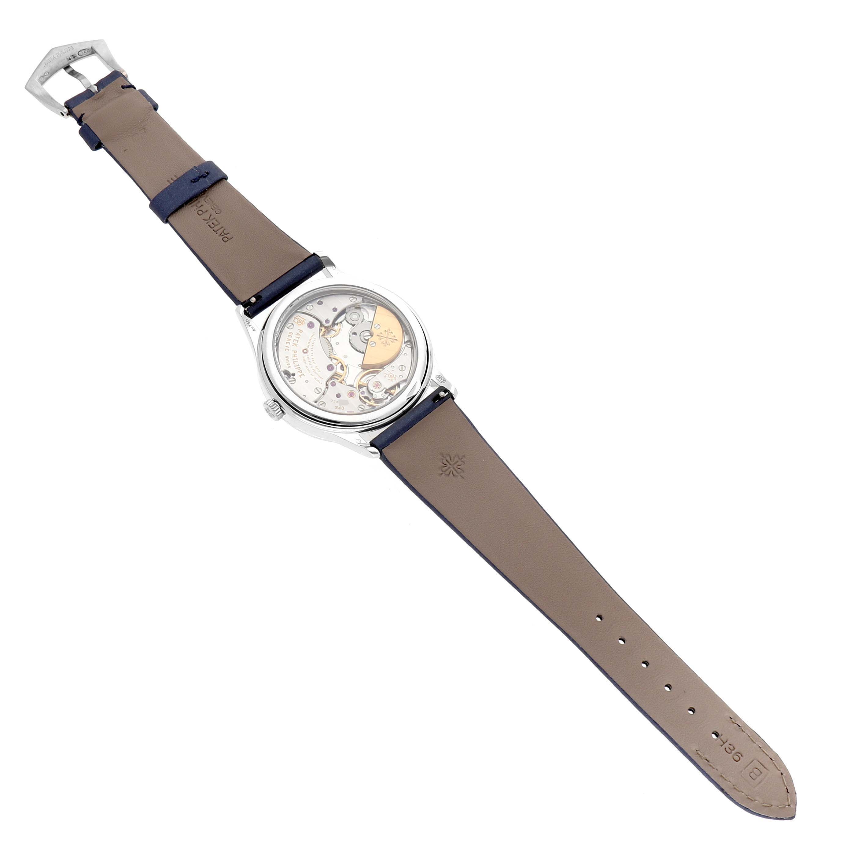 The Patek Philippe Calatrava 4997 Women's White Gold Blue Dial watch is shown from the back, displaying its movement through a transparent case back.