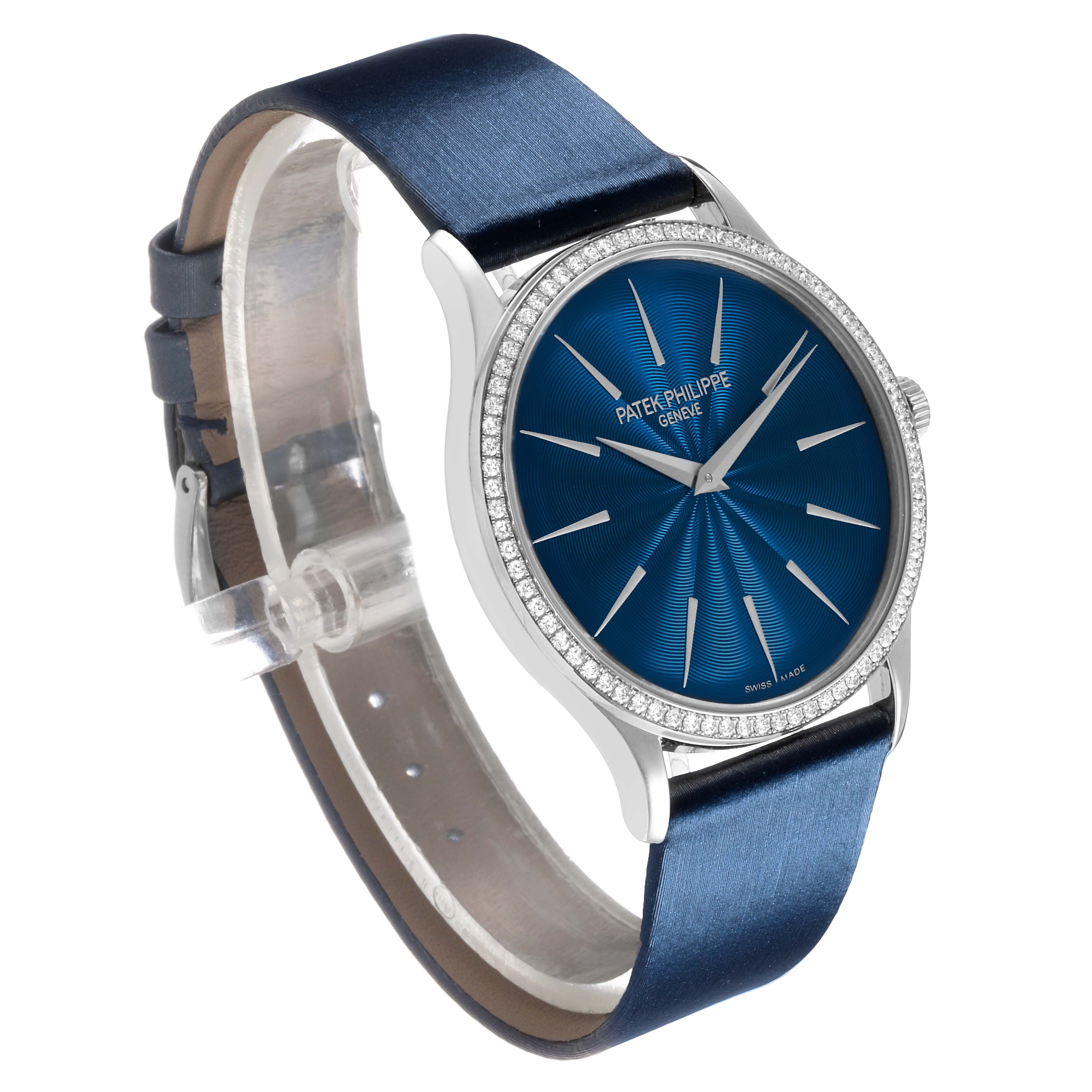 The image shows a Patek Philippe Calatrava 4997 Women's White Gold Blue Dial watch at a three-quarter angle, highlighting its blue dial, diamond bezel, and blue strap.