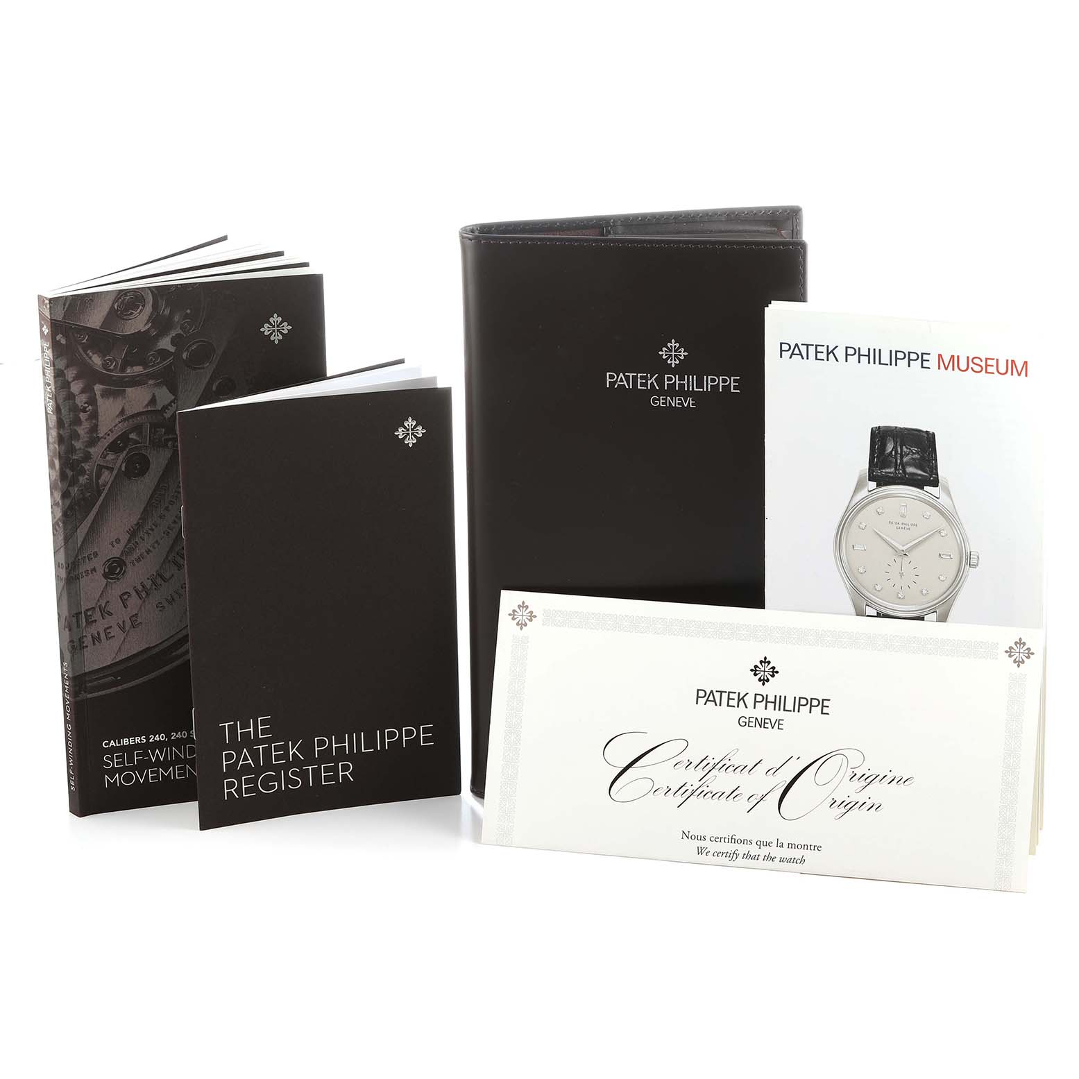 This image shows Patek Philippe Calatrava 4997 Women's White Gold Blue Dial model accessories, including booklets and a certificate of origin, from a front angle.