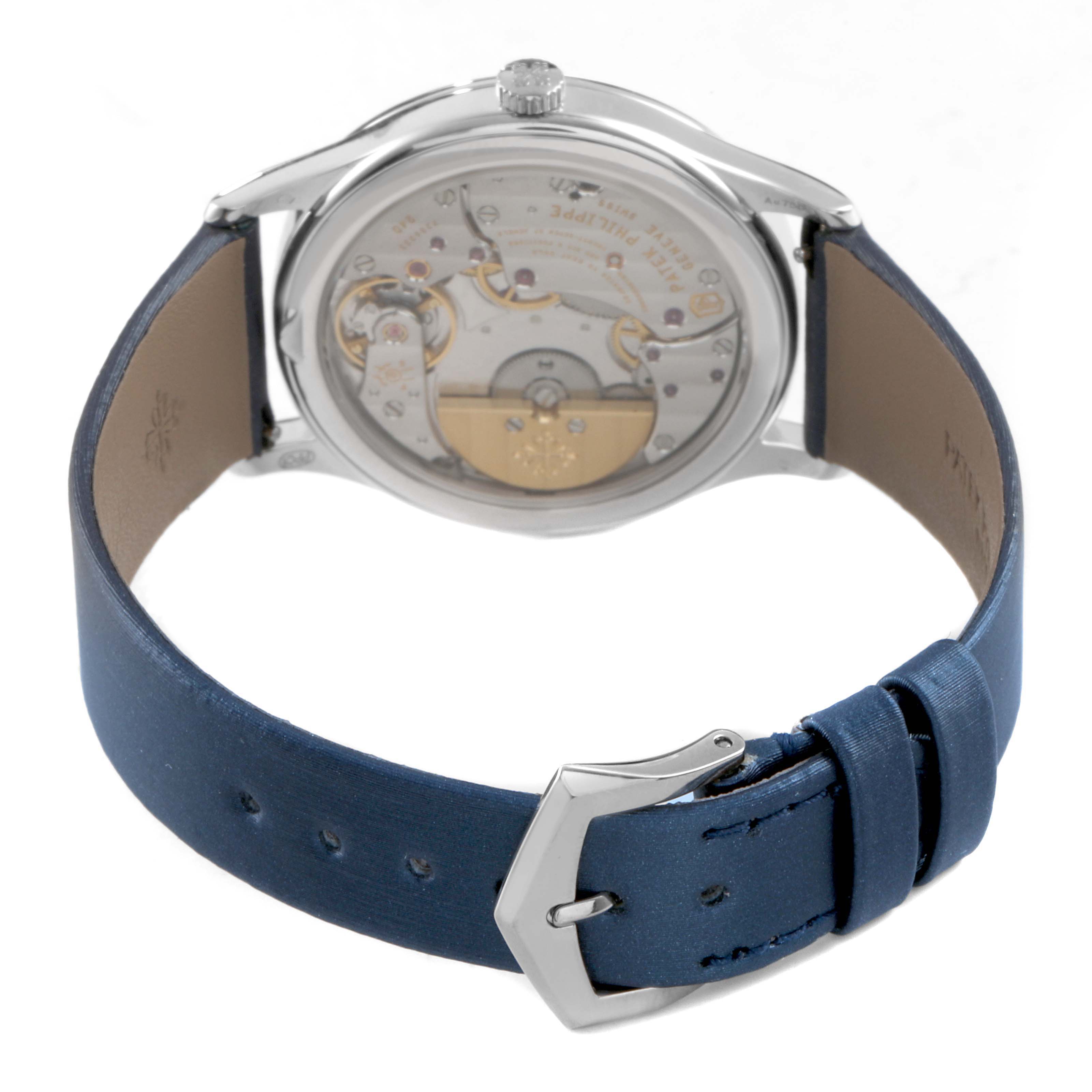 The image shows the Patek Philippe Calatrava 4997 Women's White Gold Blue Dial watch from the back, highlighting its movement and blue leather strap.
