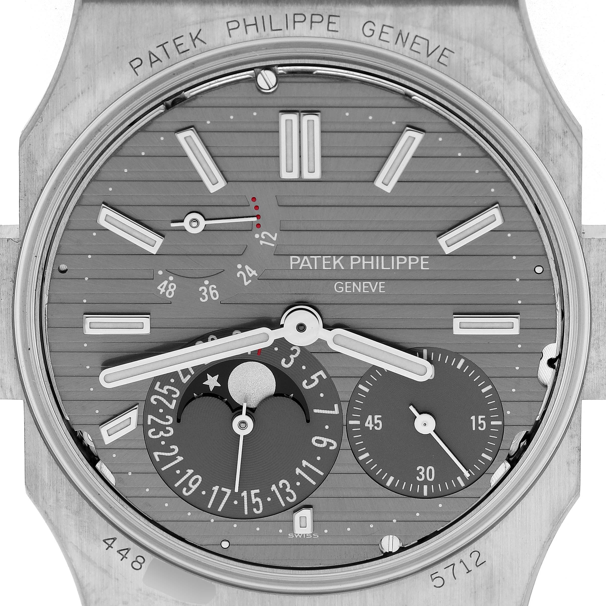 This image shows a close-up of the Patek Philippe Nautilus 5712G Men's White Gold Grey Dial watch face, displaying its dials and complications.