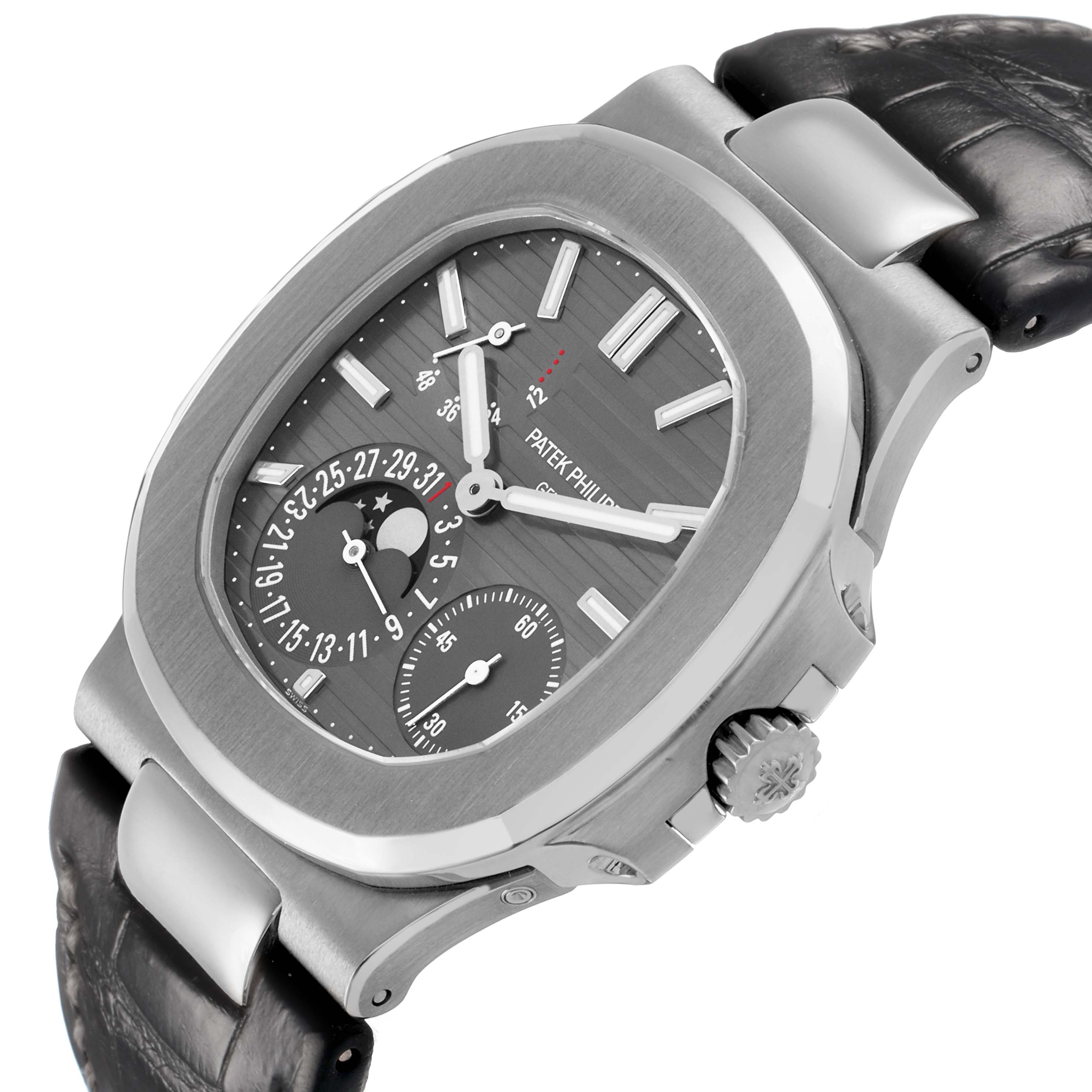 The Patek Philippe Nautilus 5712G Men's White Gold Grey Dial watch is shown at an angled side view, displaying the dial, crown, and textured leather strap.