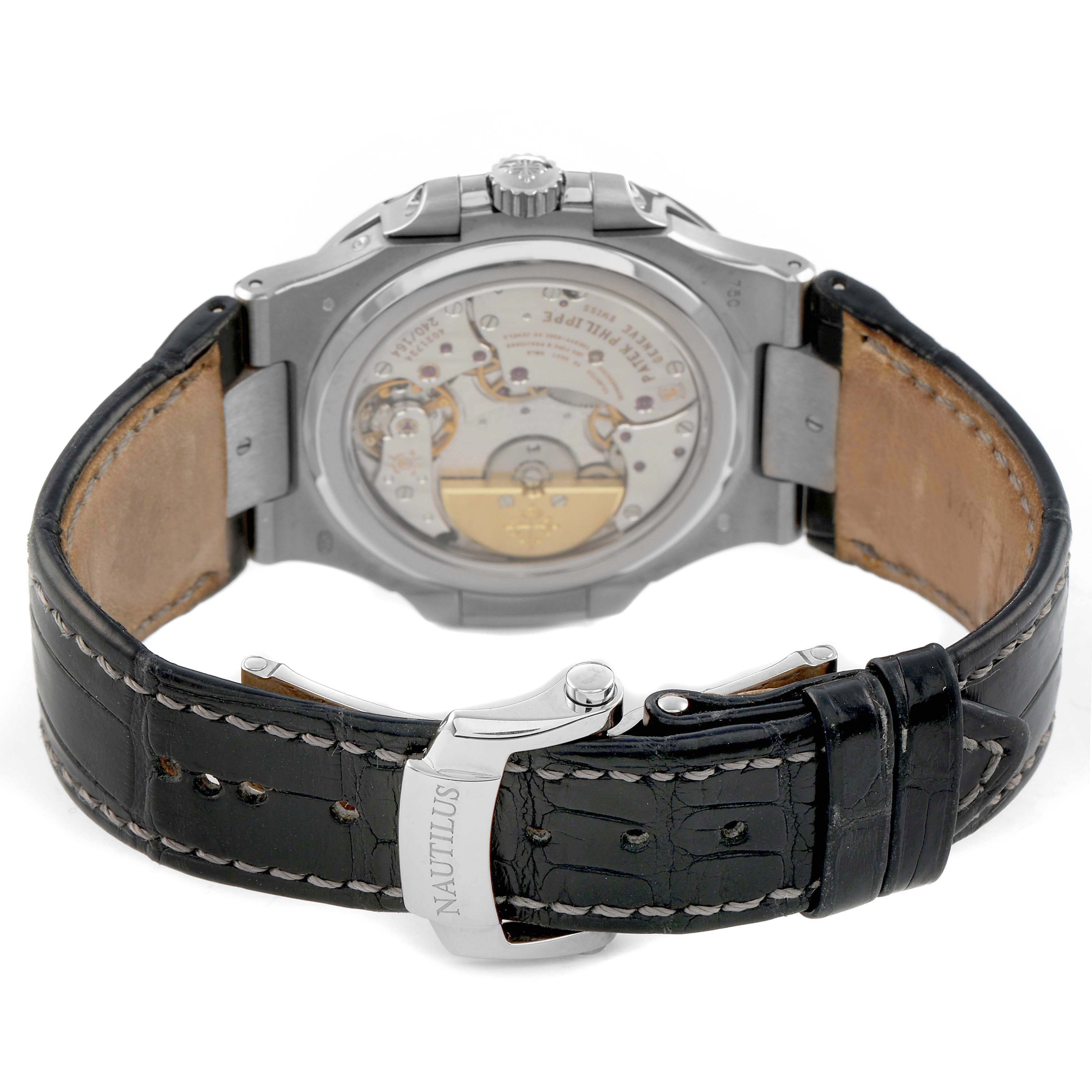 The image shows the back view of a Patek Philippe Nautilus 5712G Men's White Gold Grey Dial, highlighting the movement and leather strap with a clasp.