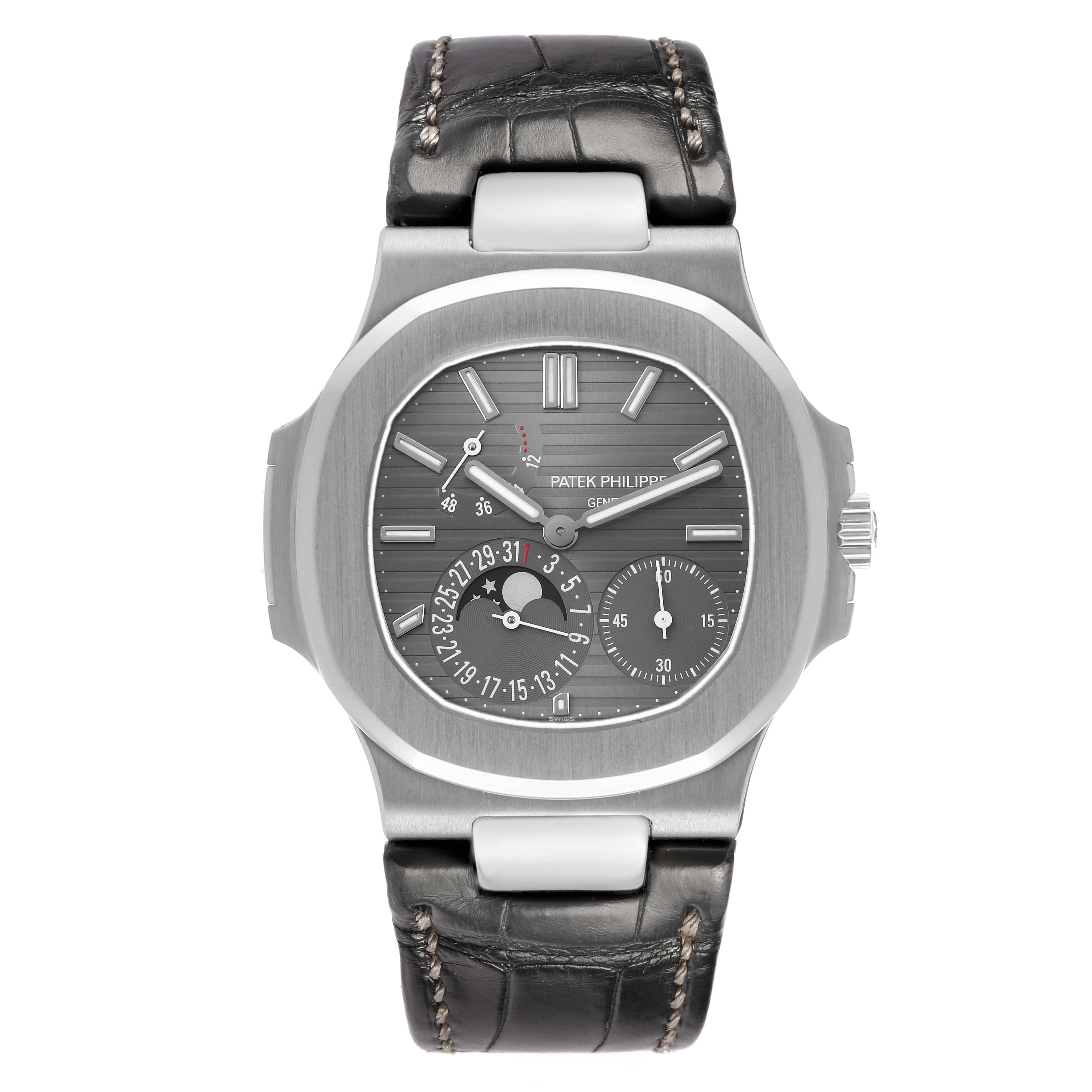 The image shows a front view of a Patek Philippe Nautilus 5712G Men's White Gold Grey Dial watch, highlighting its dial, case, and leather strap.