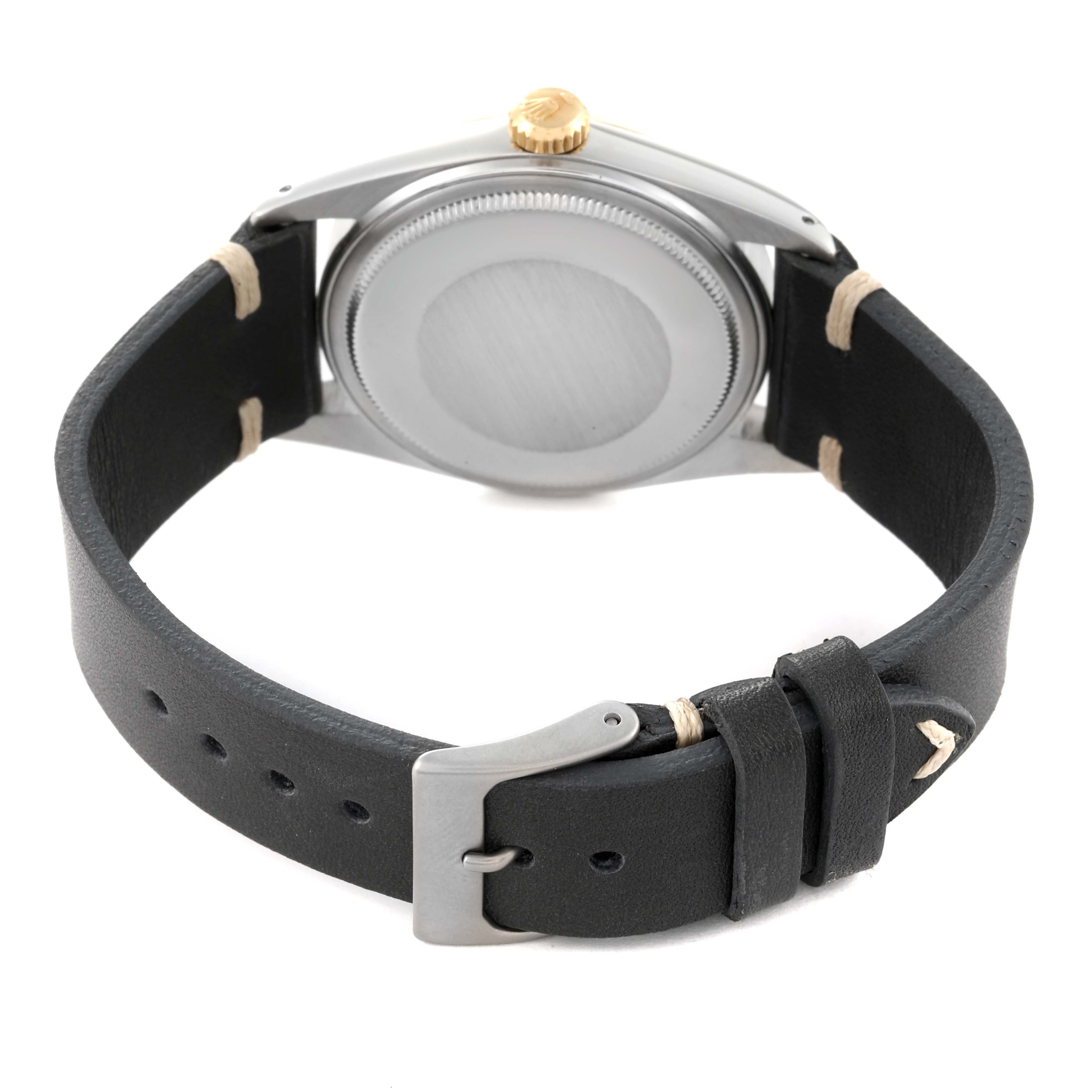 The image shows the back view of a Rolex Datejust 16013 Men's Steel and Gold (two tone) Black Dial 16013 Men's Steel and Gold (two tone) Black Dial watch with a black leather strap and a closed case back.