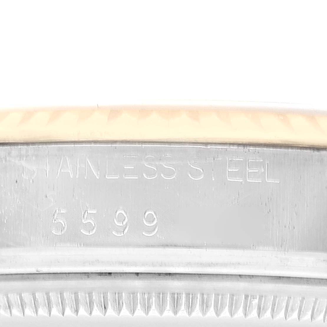 This close-up image of a Rolex Datejust 16013 Men's Steel and Gold (two tone) Black Dial 16013 Men's Steel and Gold (two tone) Black Dial watch shows the edge of the case and the serial number engraving.