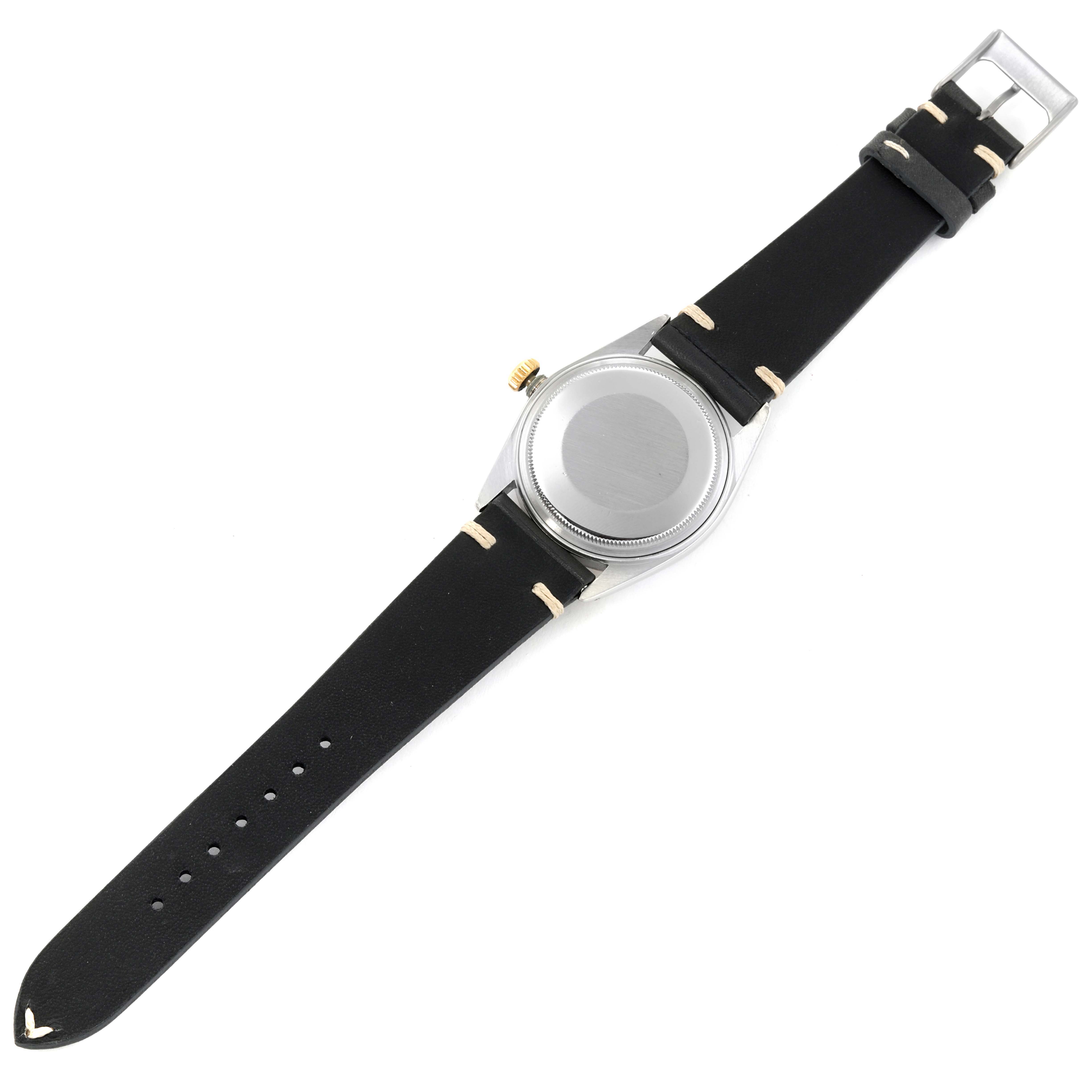 This image shows the back case and leather strap of a Rolex Datejust 16013 Men's Steel and Gold (two tone) Black Dial 16013 Men's Steel and Gold (two tone) Black Dial watch from an overhead angle.