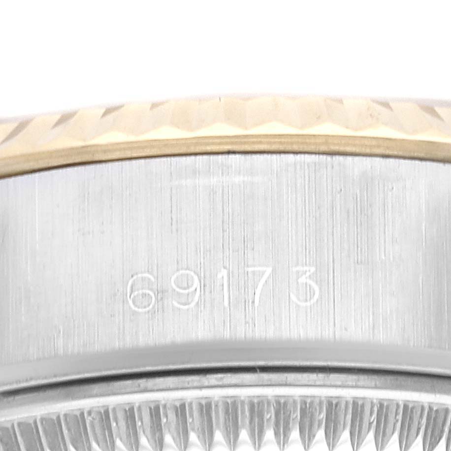 This close-up image shows the side of the bezel and case of a Rolex Datejust 69173G Women's Steel and Gold (two tone) Champagne Dial 69173G Women's Steel and Gold (two tone) Champagne Dial watch, featuring the model number "69173."