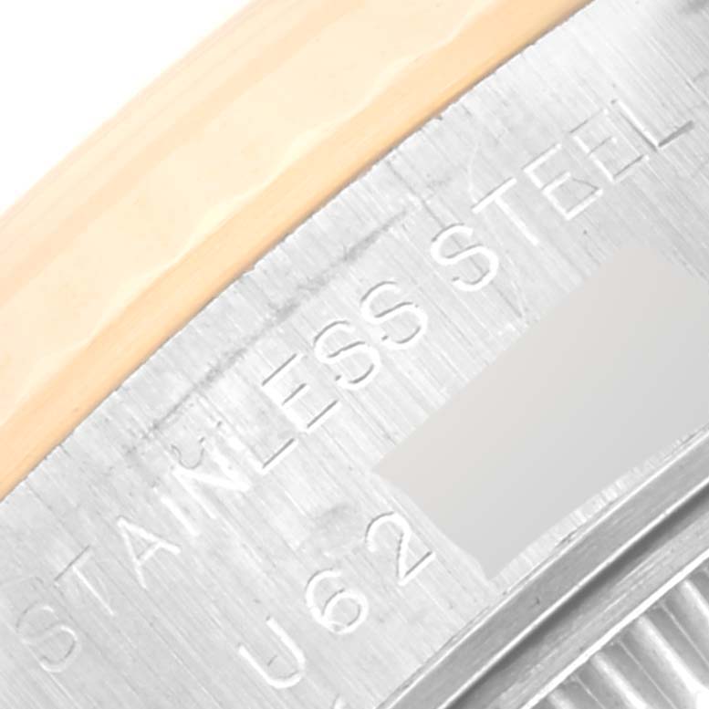 The image shows a close-up angle of the engraved text "STAINLESS STEEL" on the bezel of a Rolex Datejust 69173 Women's Steel and Gold (two tone) Champagne Dial 69173 Women's Steel and Gold (two tone) Champagne Dial watch.