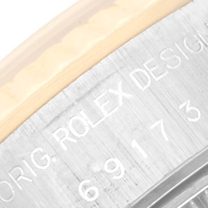 This image shows a close-up of the edge and inscription on the case of a Rolex Datejust 69173 Women's Steel and Gold (two tone) Champagne Dial 69173 Women's Steel and Gold (two tone) Champagne Dial watch.