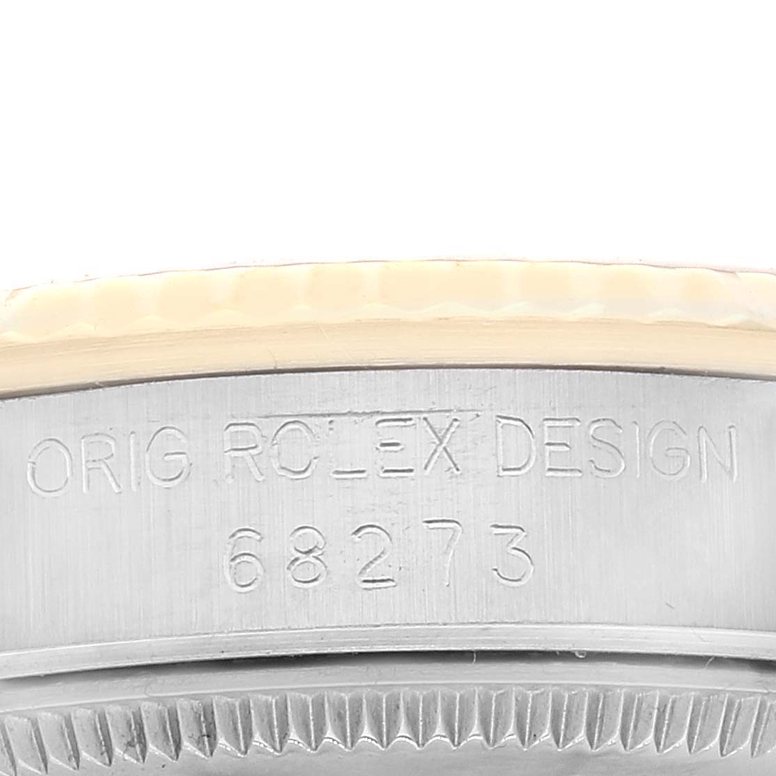 This close-up image of a Rolex Mid-Size 68273 Women
s Steel and Gold (two tone) Champagne Dial 68273 Women
s Steel and Gold (two tone) Champagne Dial watch shows the engraved bezel with "ORIG ROLEX DESIGN 68273".