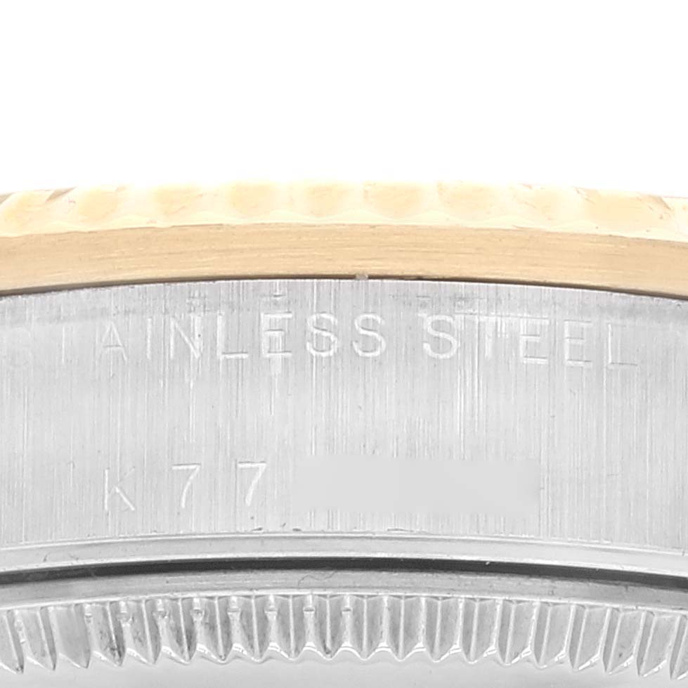 This image shows a close-up of the side of a Rolex Mid-Size 78273 Women's Steel and Gold (two tone) Champagne Dial 78273 Women's Steel and Gold (two tone) Champagne Dial watch case, displaying the stainless steel marking.