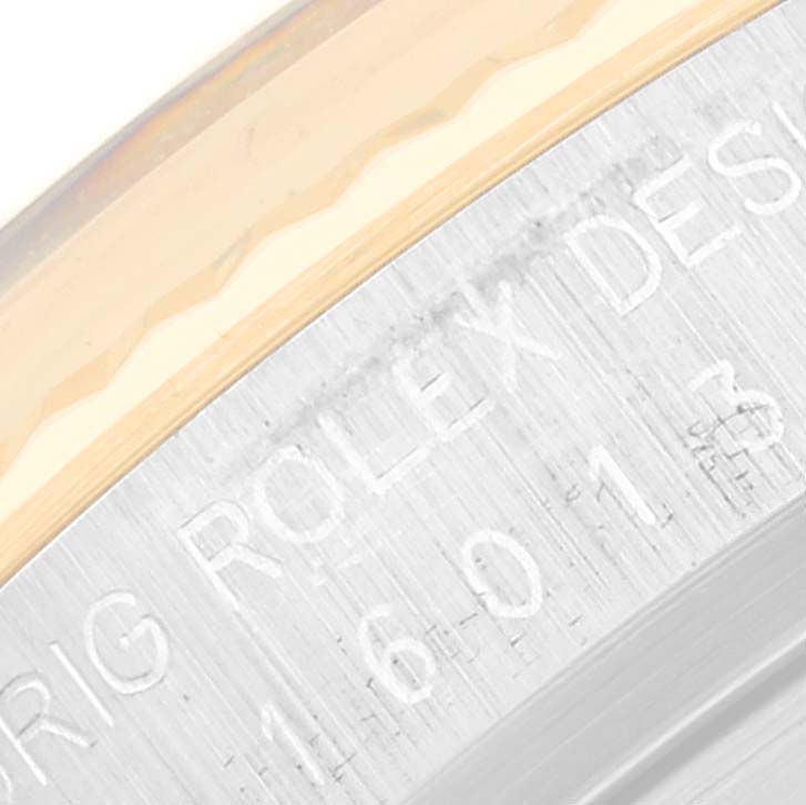 This image shows an angled, close-up view of the engraved side of the Vintage Collection Rolex watch case.