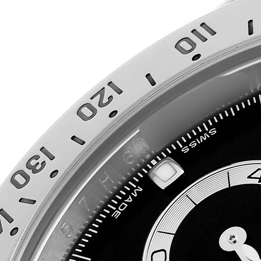 The image shows a close-up of the bezel and part of the dial of a Rolex Daytona 116520 Men's Stainless Steel Black Dial 116520 Men's Stainless Steel Black Dial watch, focusing on the tachymeter scale.