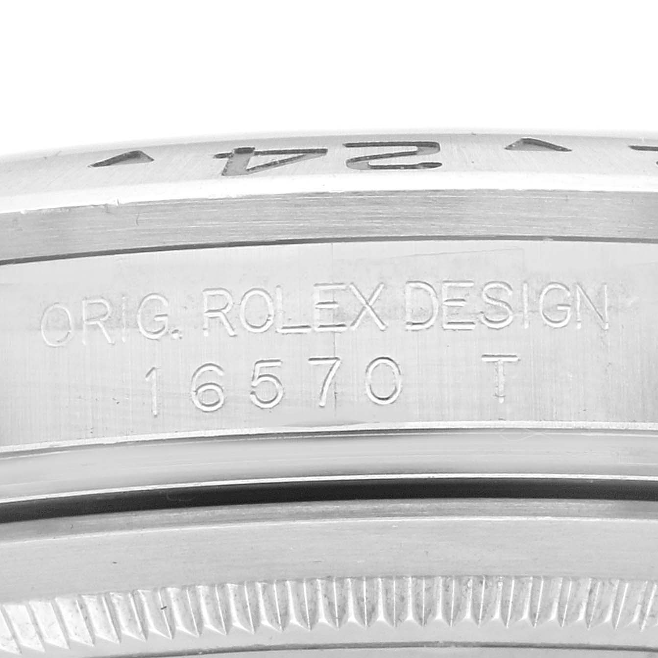 The image shows a close-up of the inner bezel and engraved details of a Rolex Explorer 16570 Men
s Stainless Steel White Dial 16570 Men
s Stainless Steel White Dial model 16570 T.