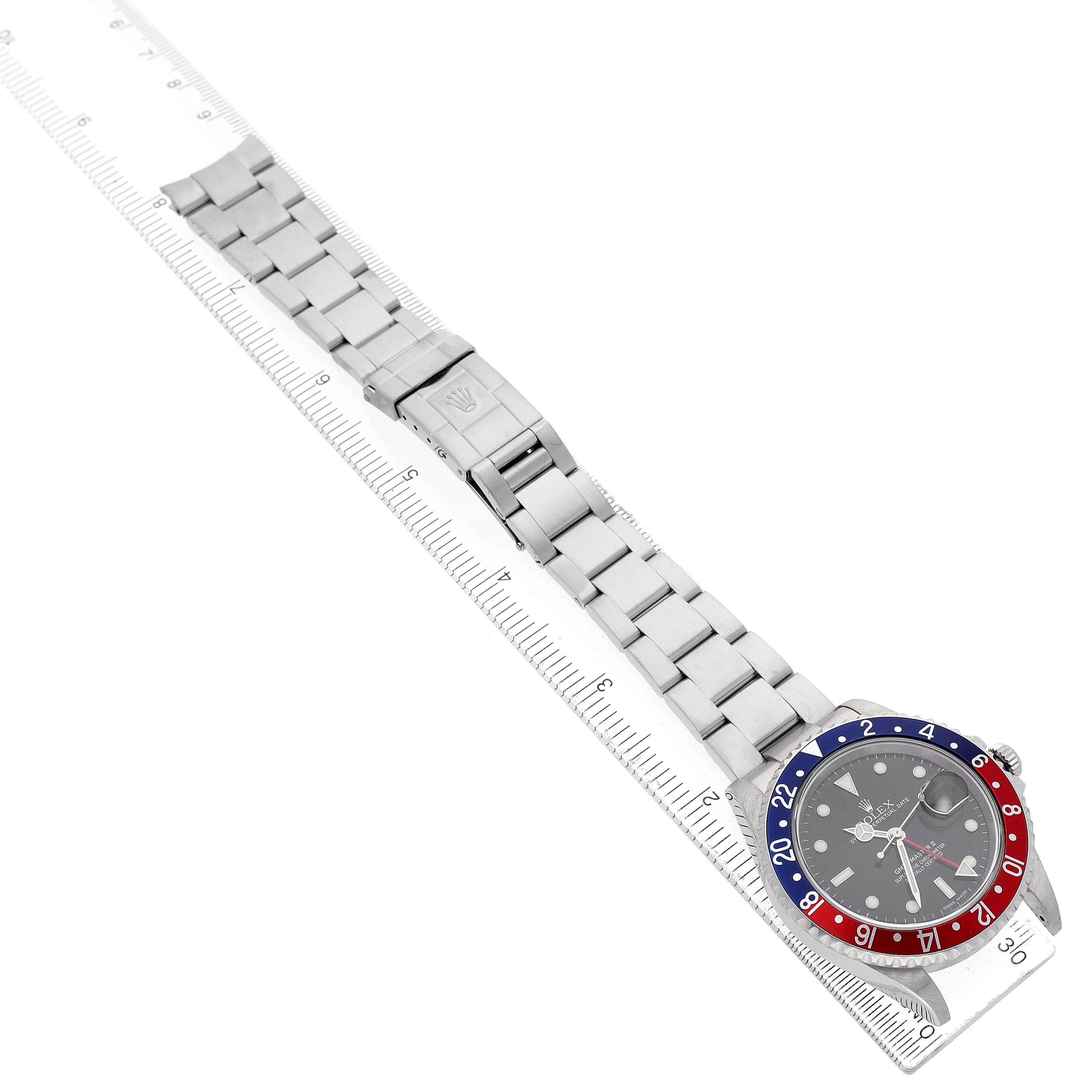 The Rolex GMT-Master 16710 Men's Stainless Steel Black Dial watch is shown diagonally from a top-down angle, displaying its bezel, face, and bracelet.